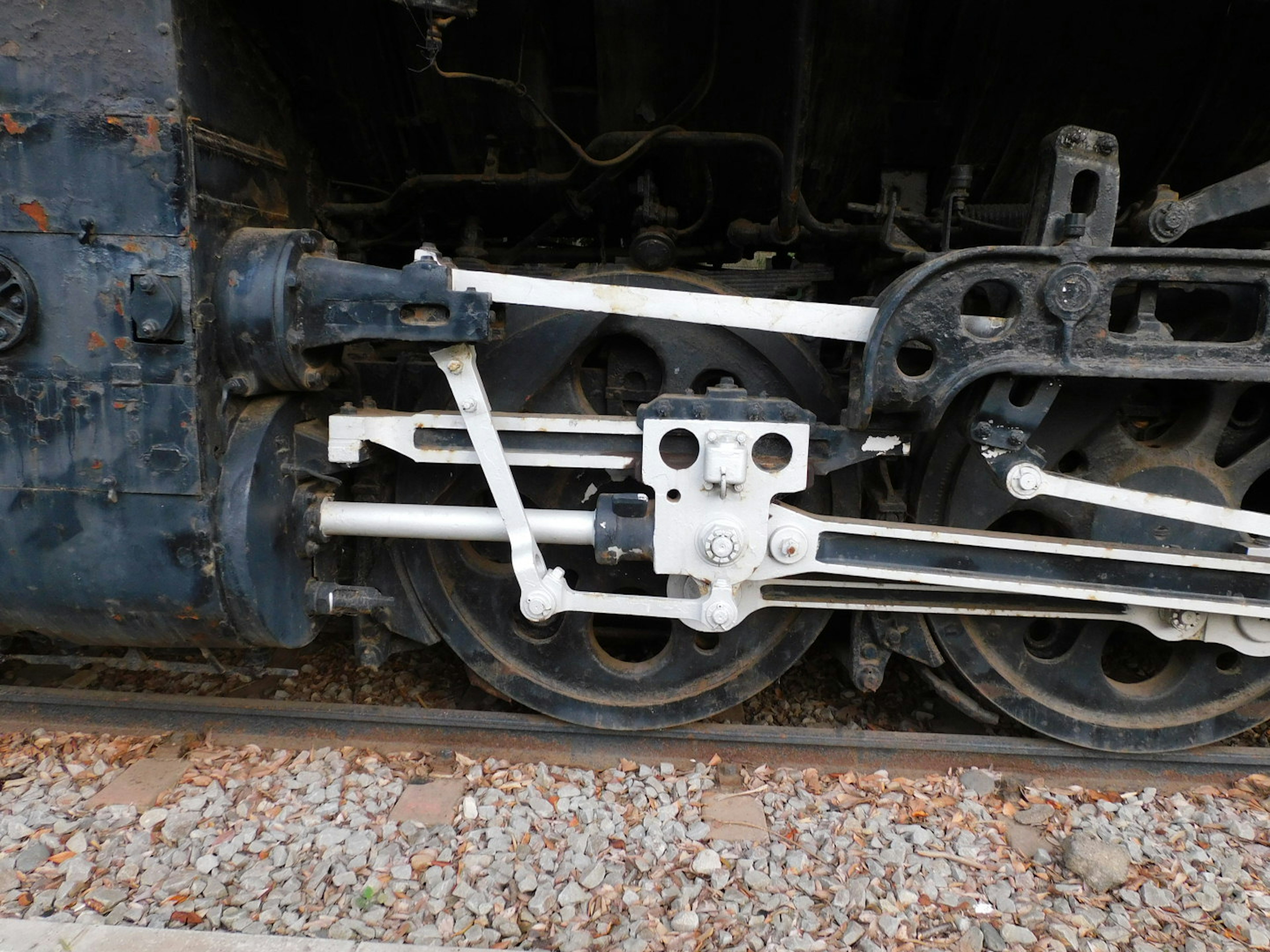 Detailed view of steam locomotive drive wheels and connecting rods