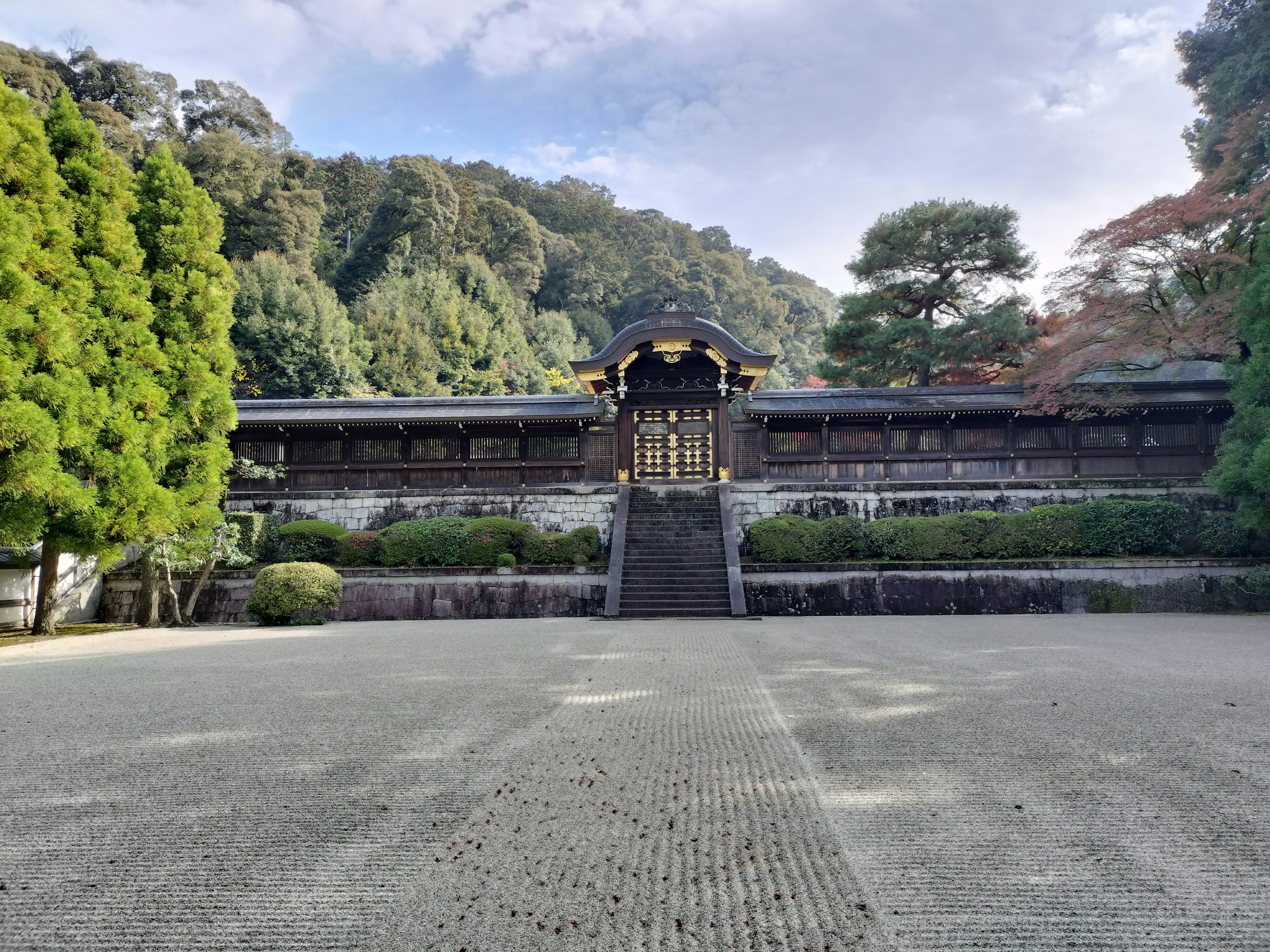 Historic building surrounded by lush greenery in a serene garden