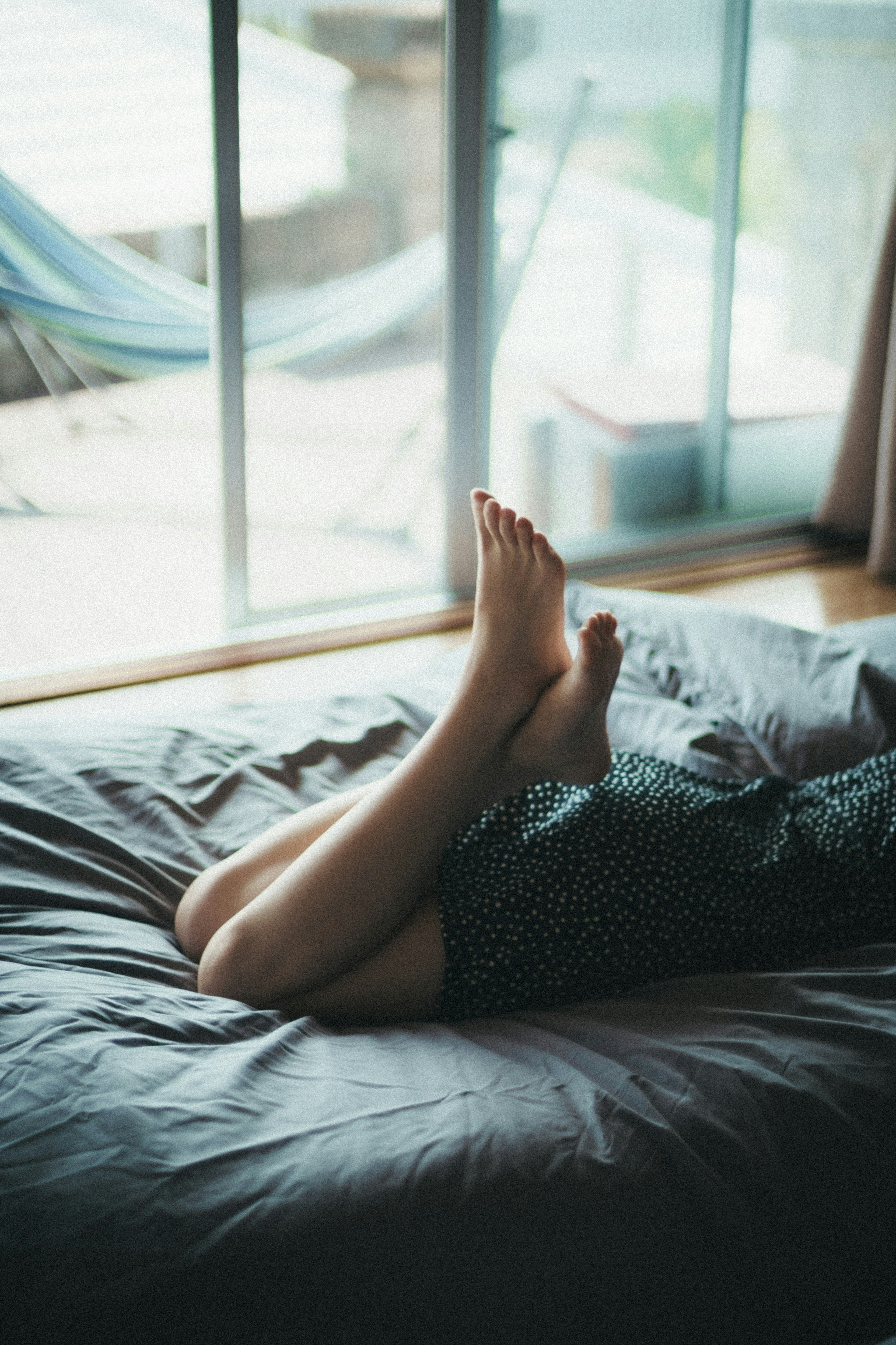 Pieds et jambes détendus sur un lit