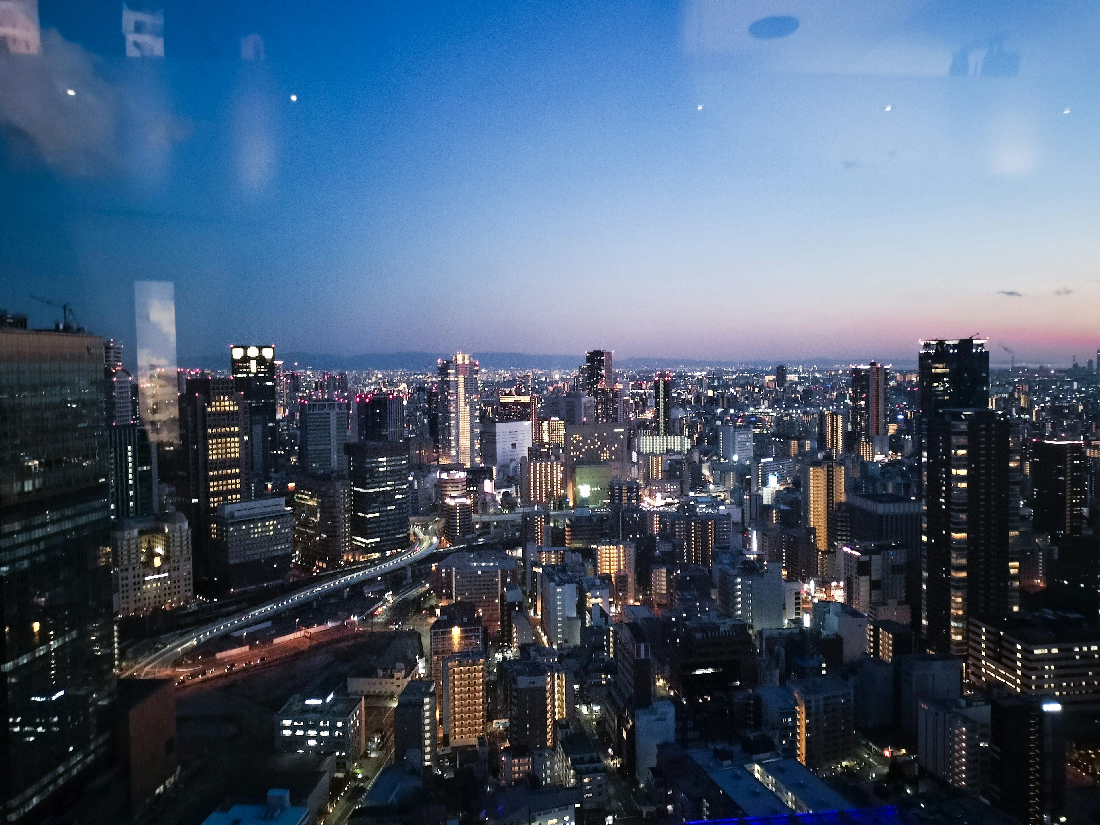 Night view of Tokyo skyline with skyscrapers and blue sky