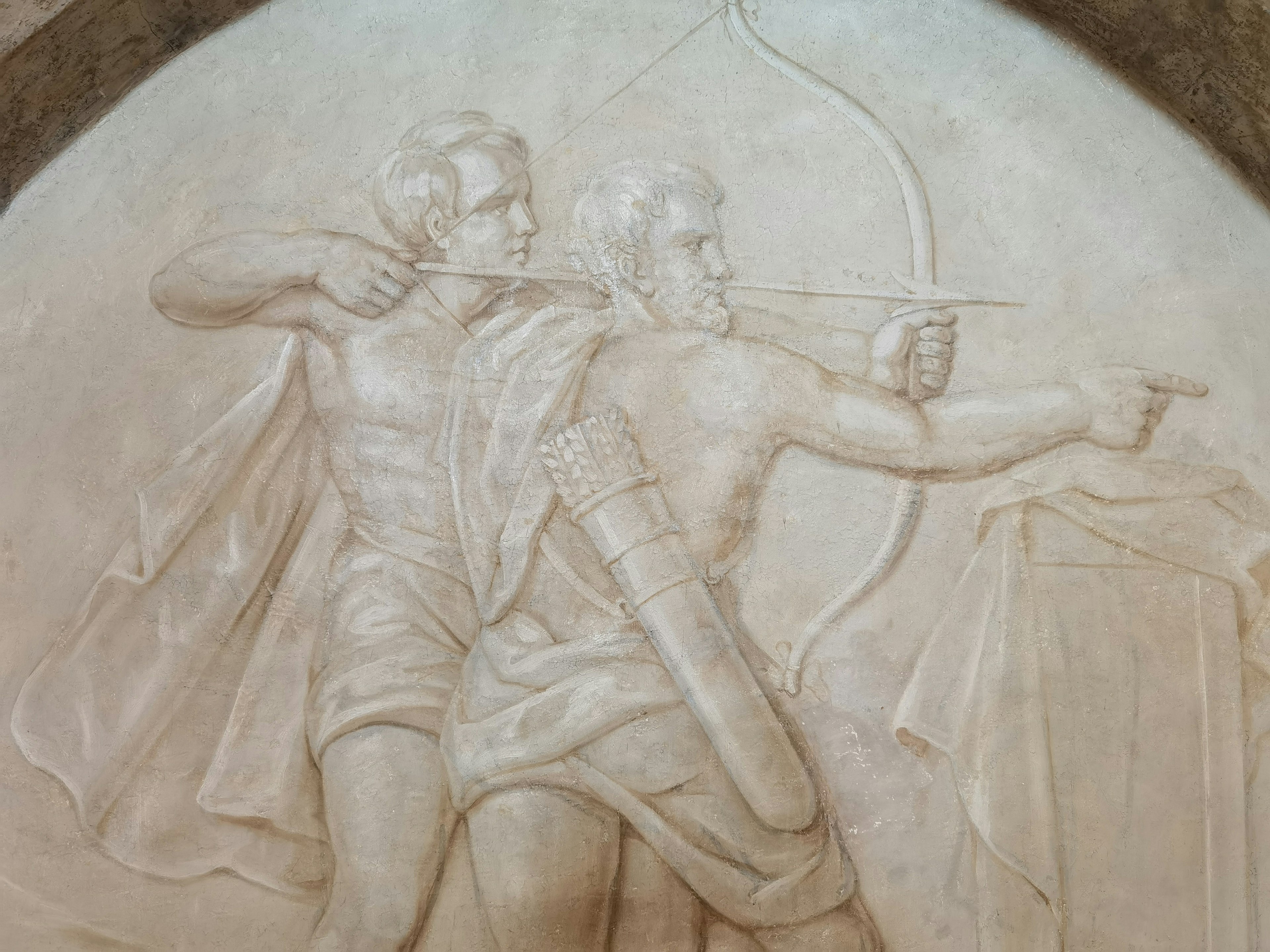 Two archers in a sculpted relief aiming at a target