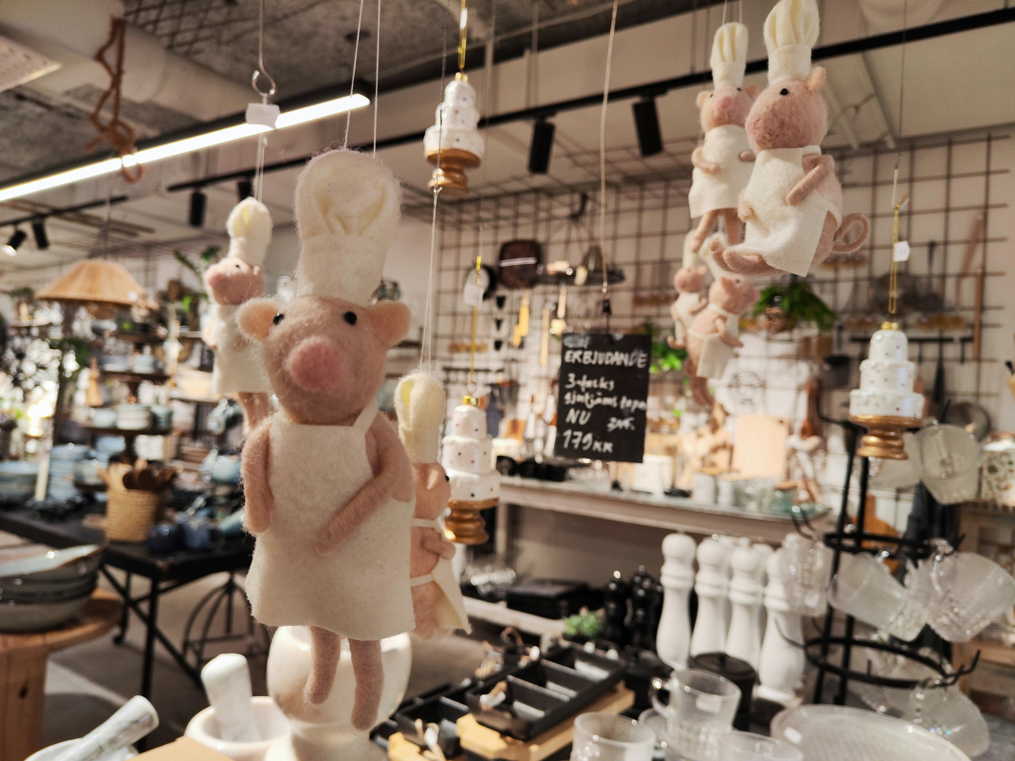 Hanging chef pig figurines in a kitchenware store