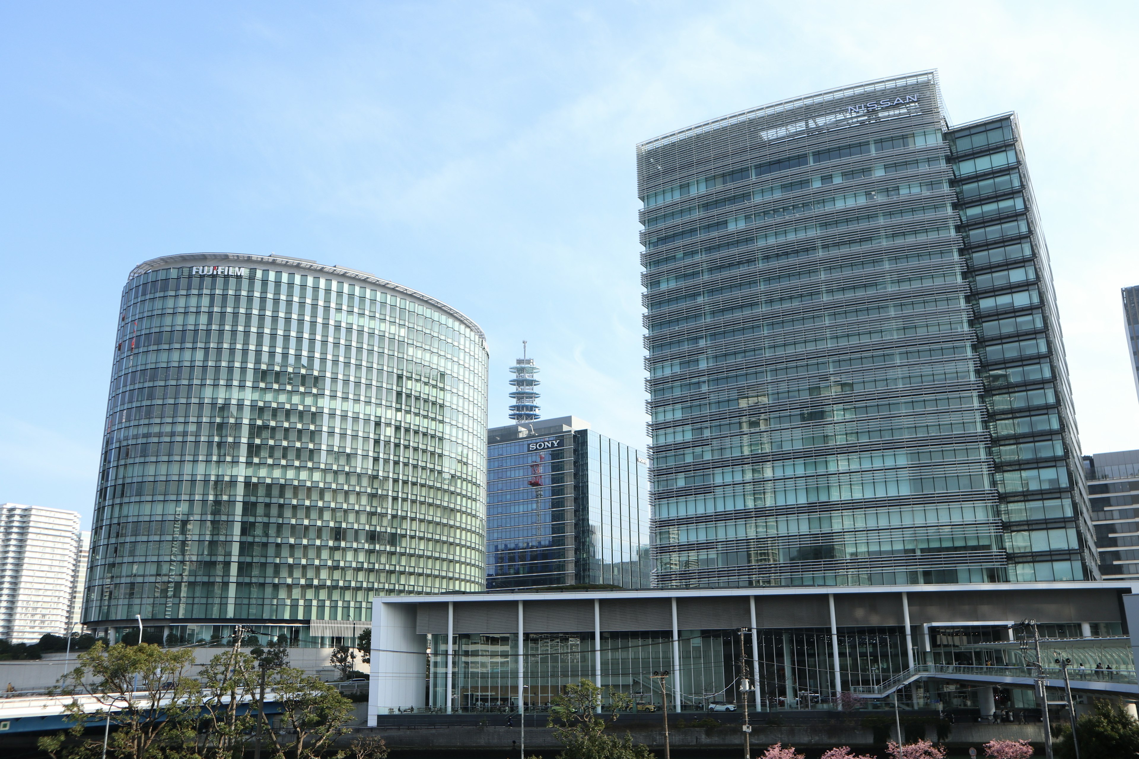 Modern cityscape featuring glass buildings and blue sky