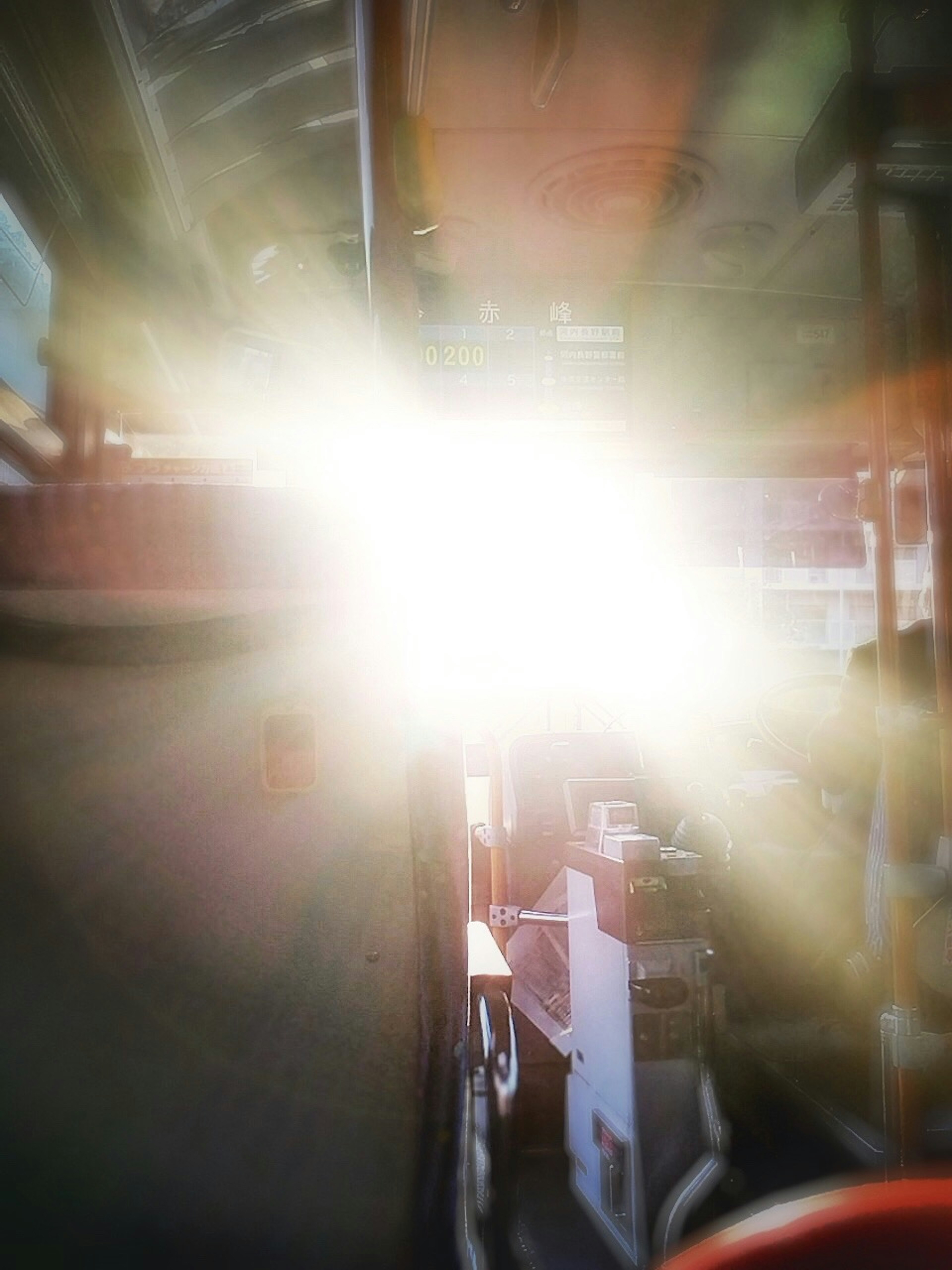 Bright sunlight streaming through a bus interior creating a soft glow