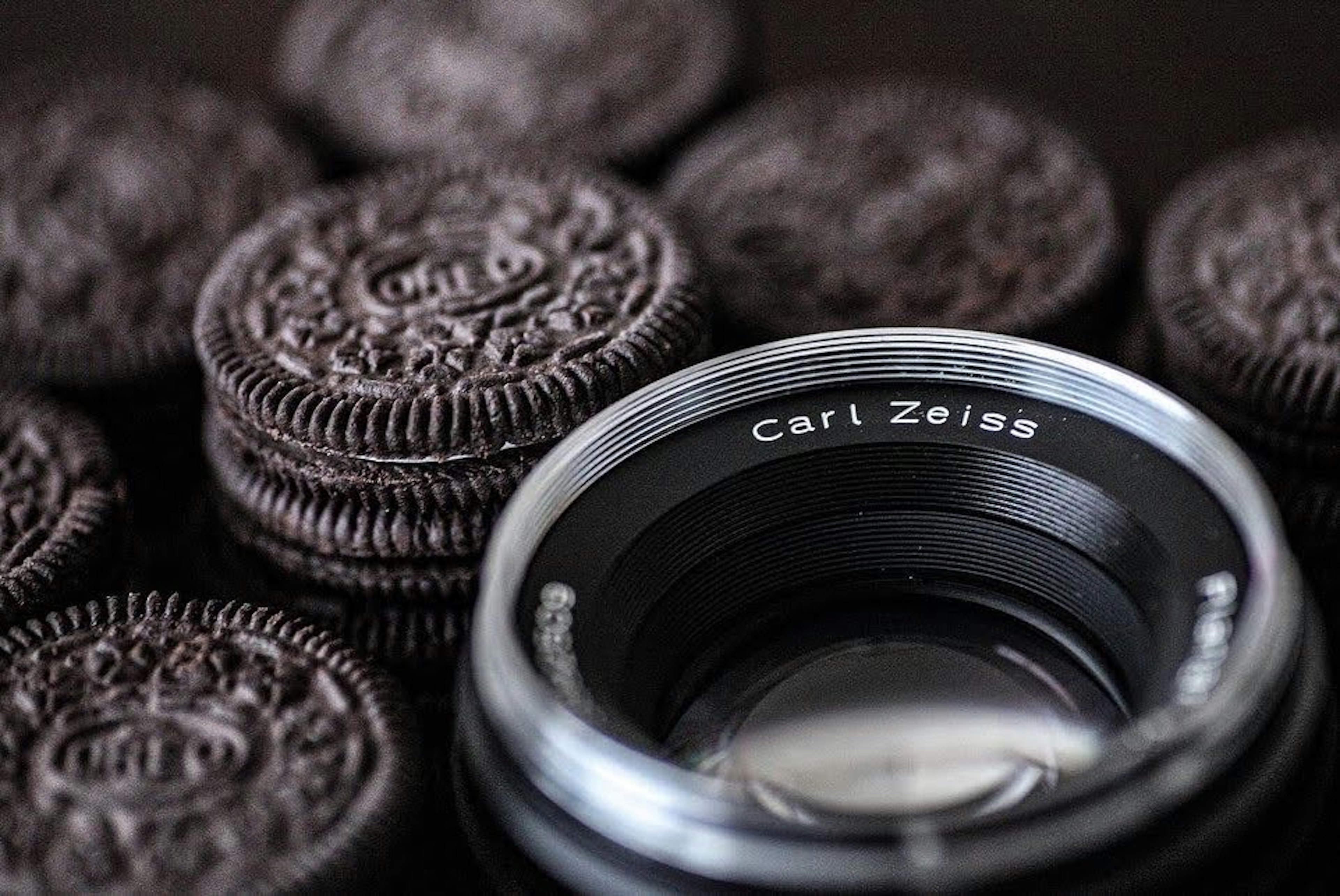 Image featuring a Carl Zeiss lens surrounded by Oreo cookies