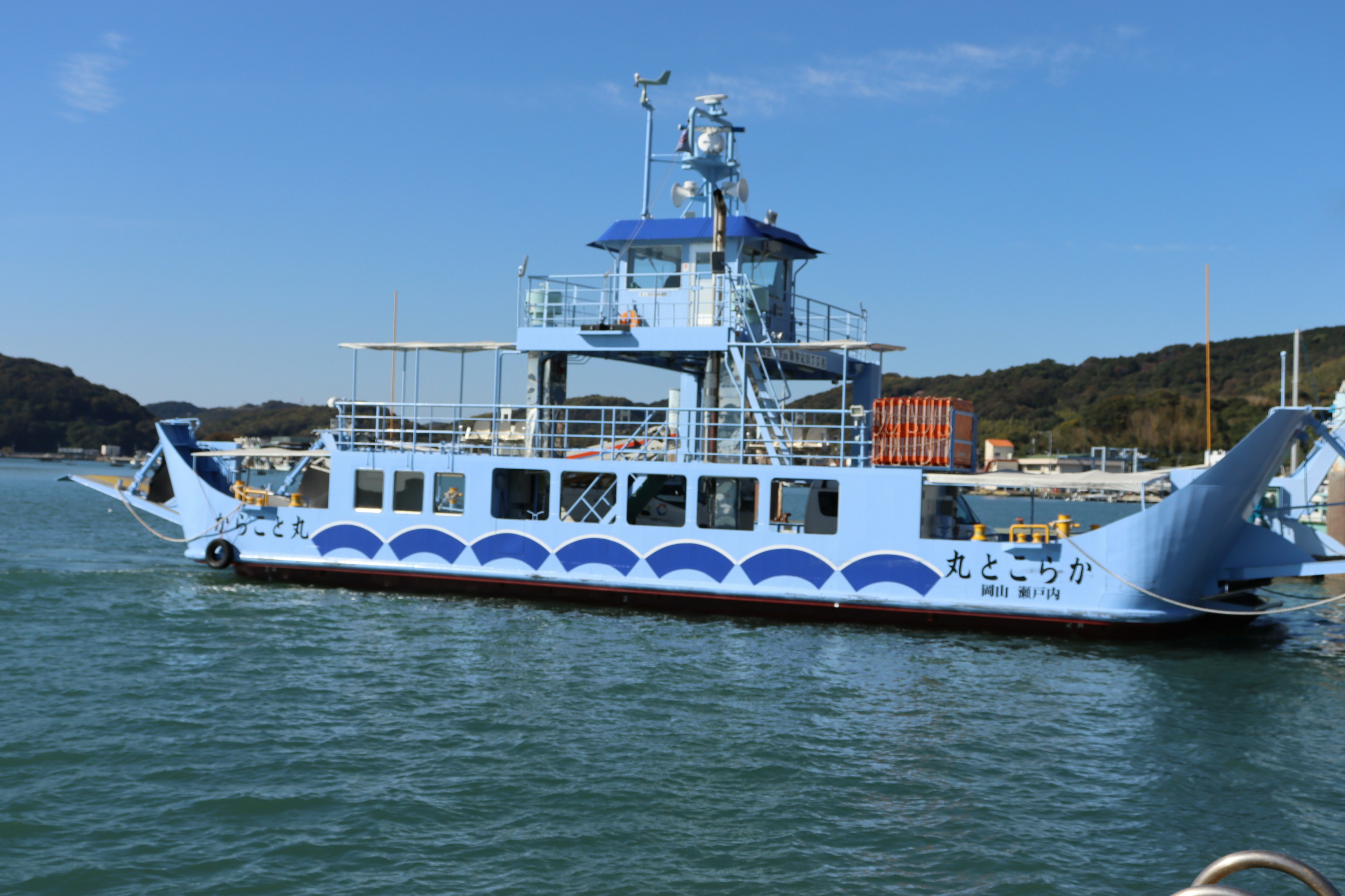 A blue ferry boat navigating through the water