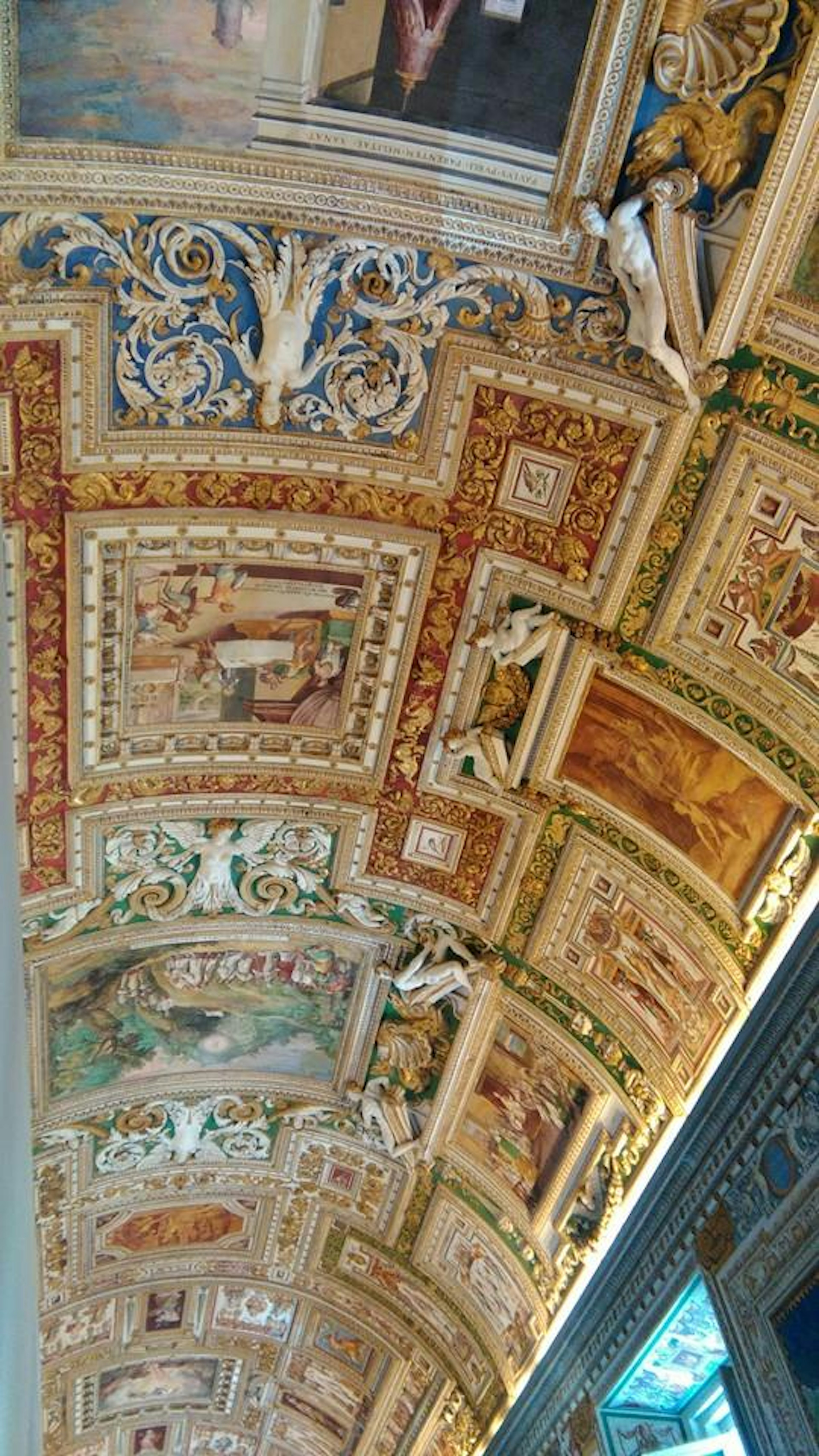 Beautifully decorated ceiling with paintings and sculptures from the Vatican Museums