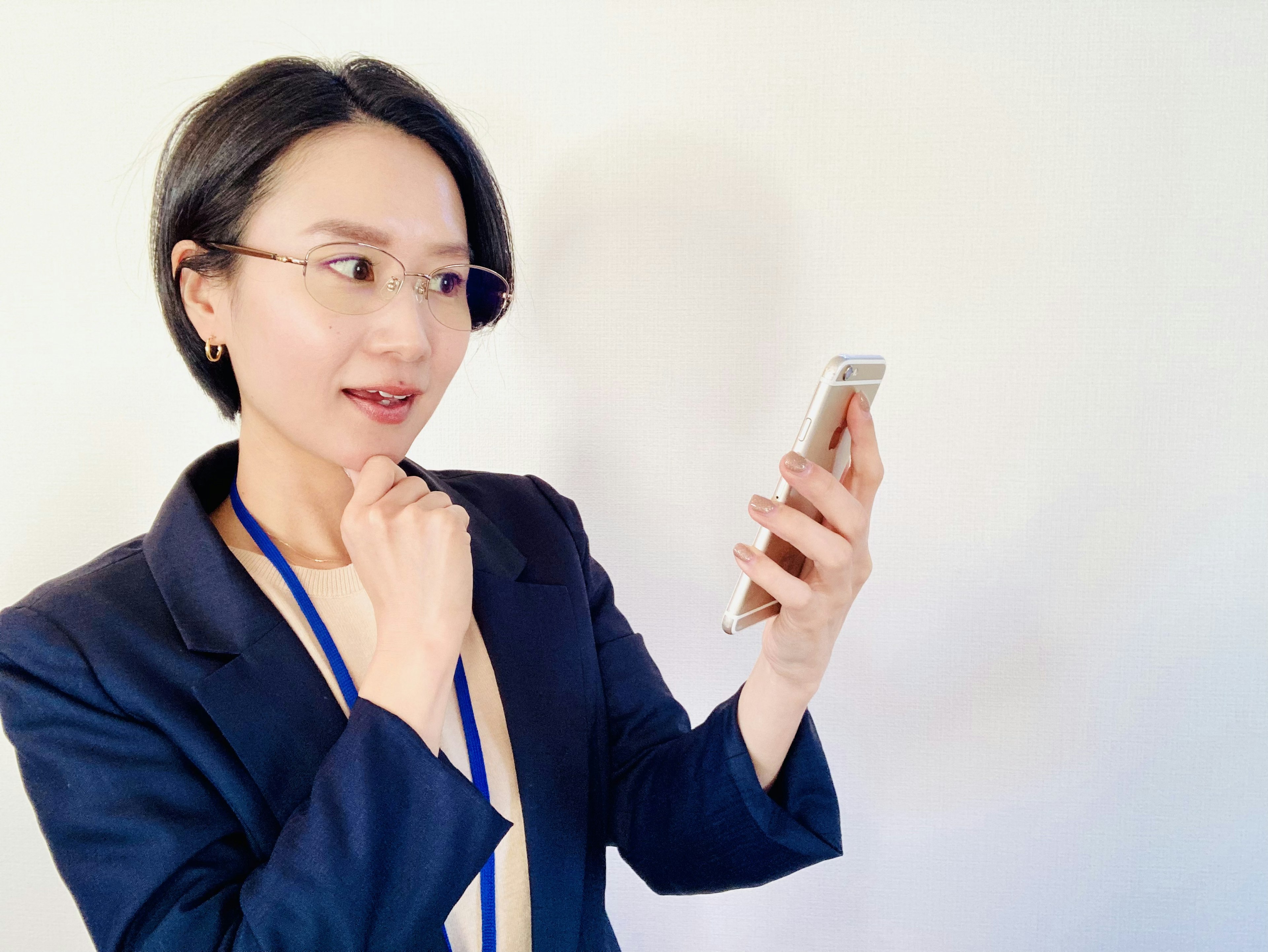 Businesswoman contemplating while looking at smartphone