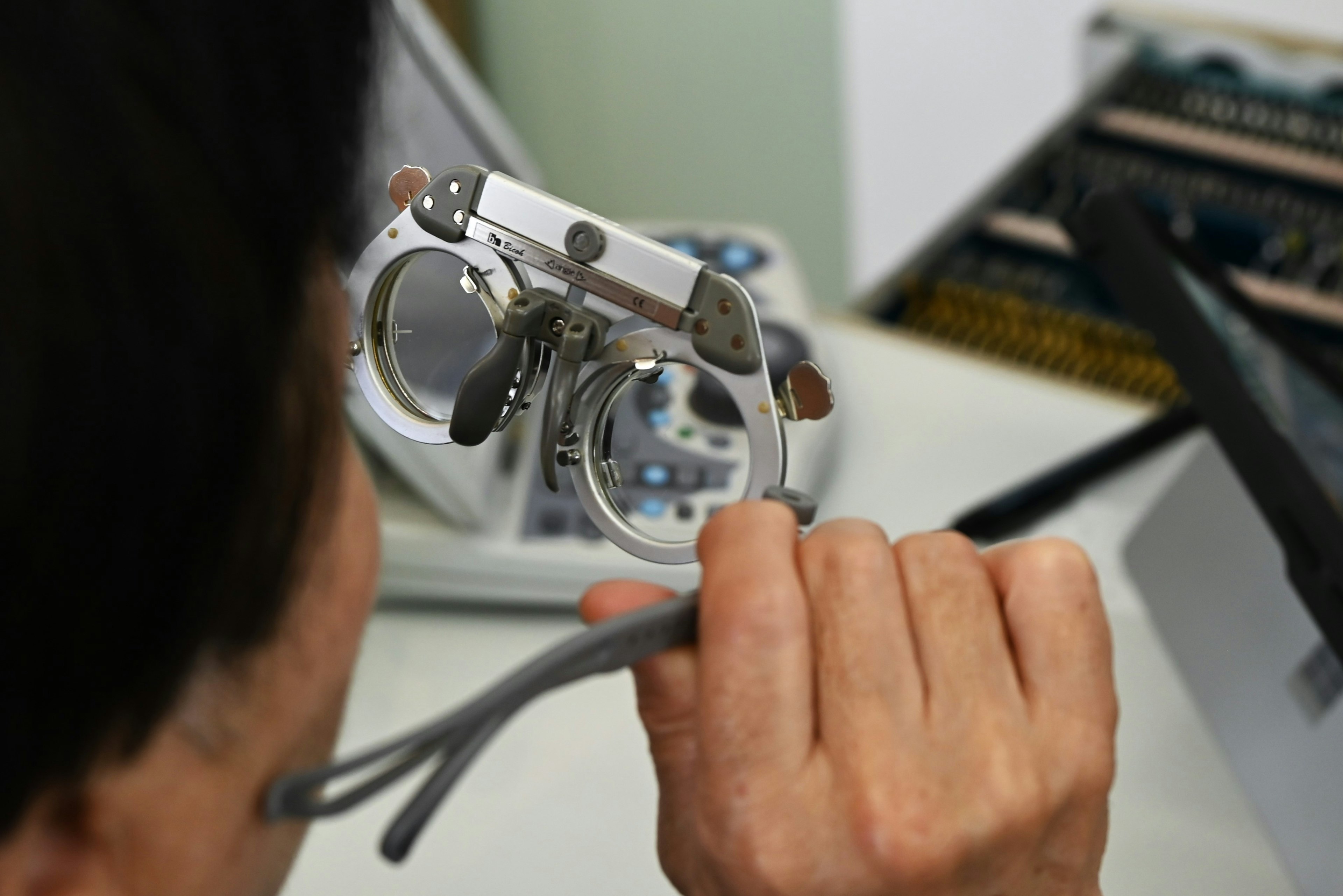 Man trying on glasses for vision testing