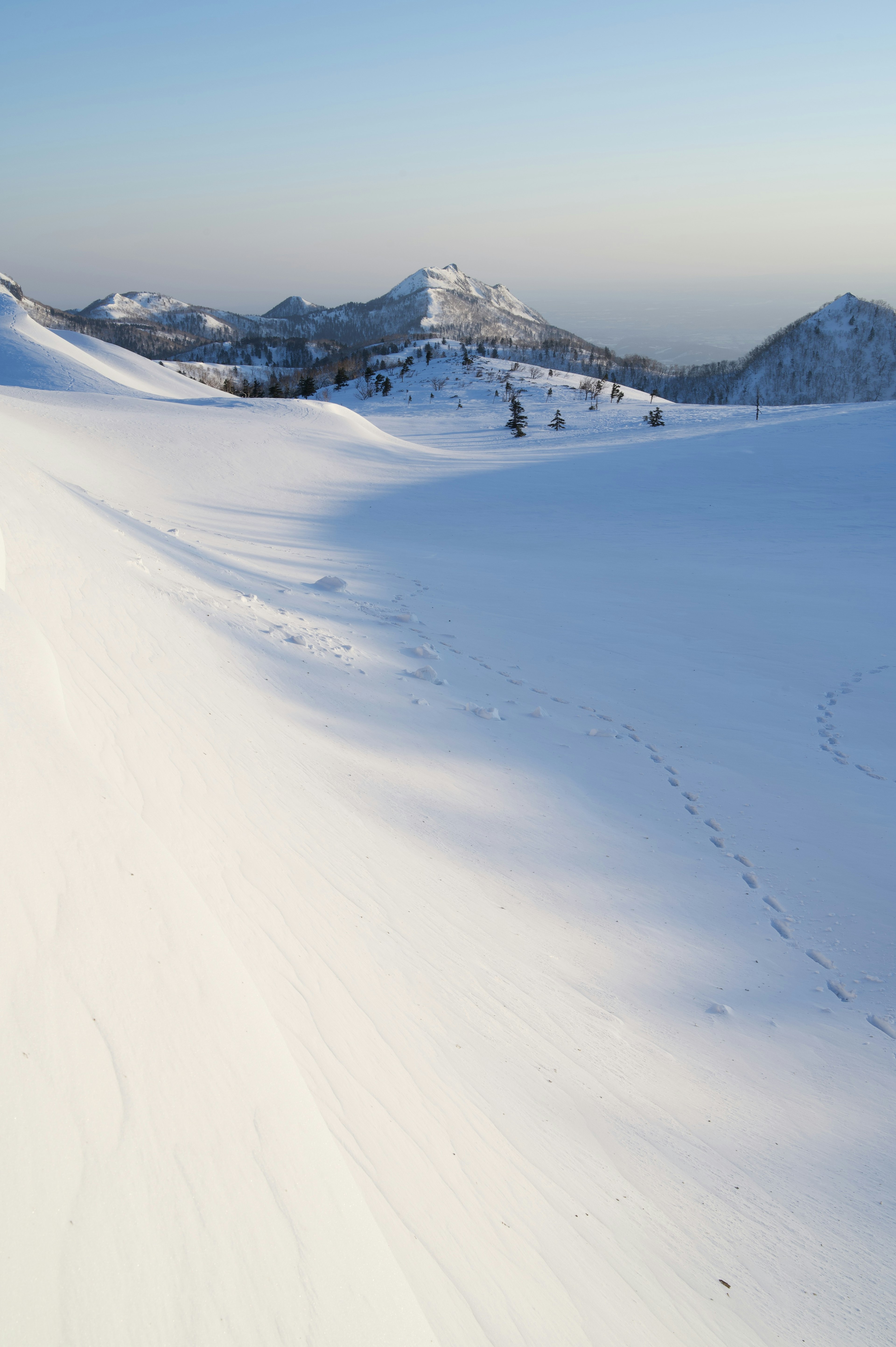 Snow-covered mountains with clear blue sky