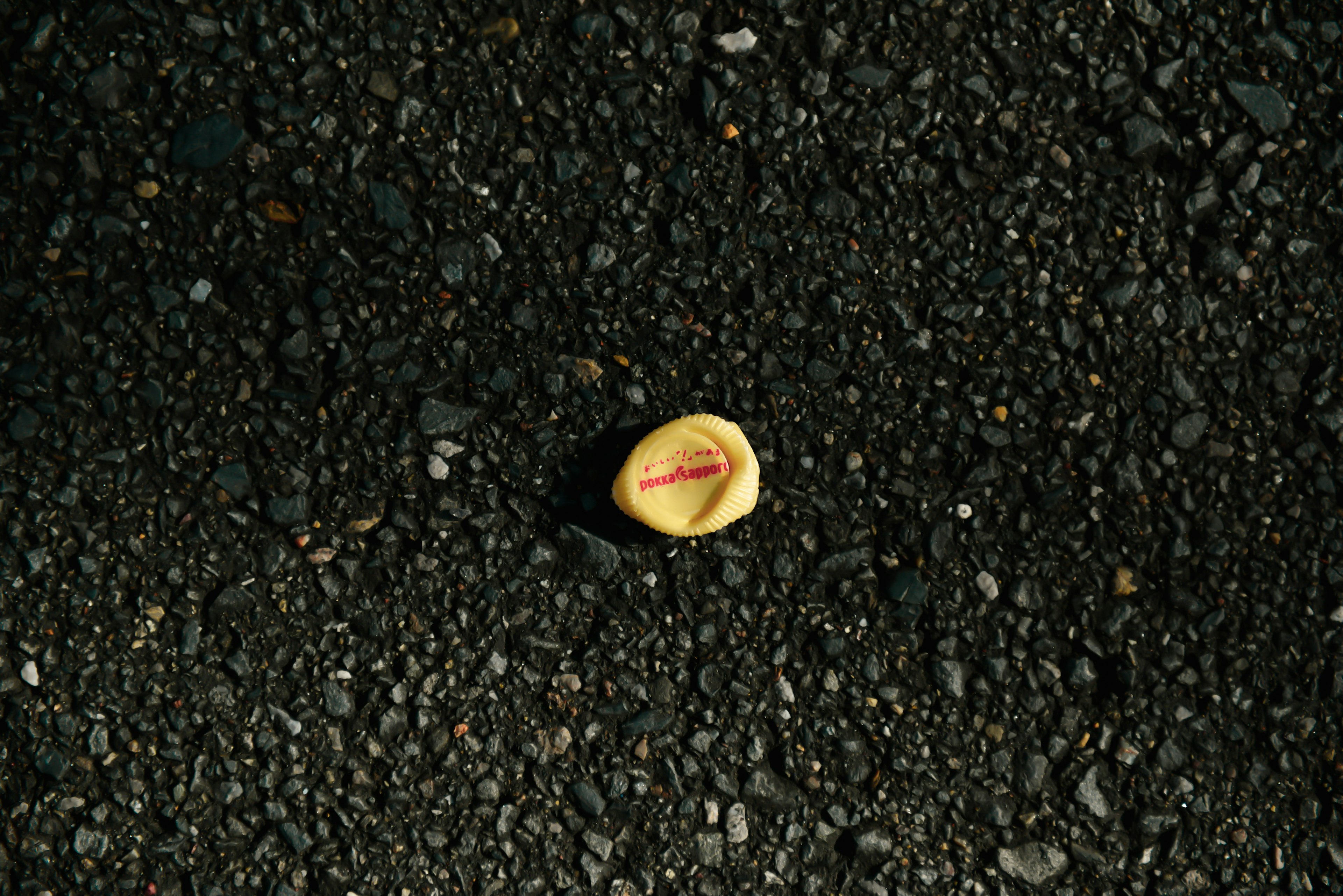 A yellow fruit-like object on the ground