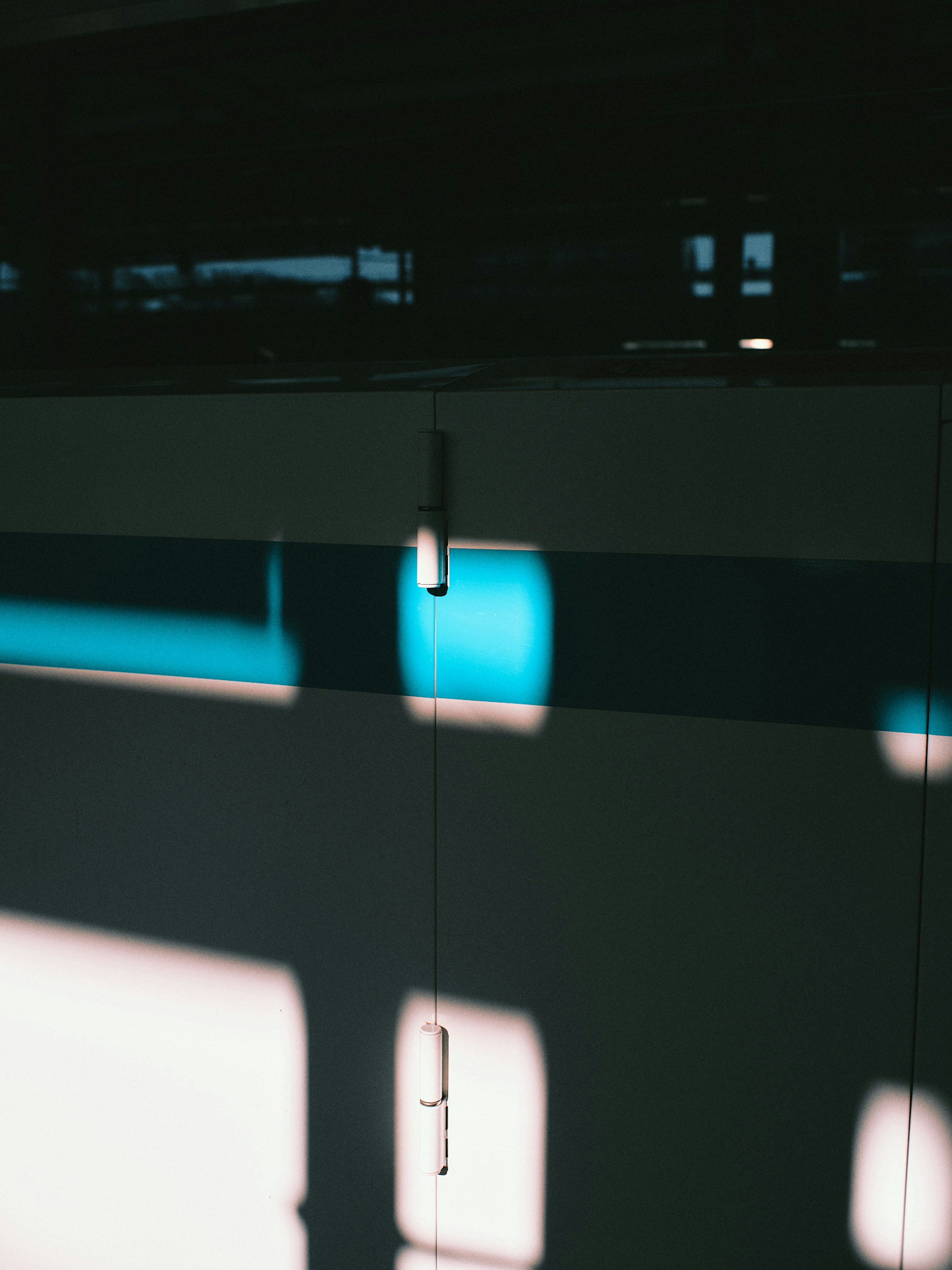 Wall with blue and white stripes featuring shadows