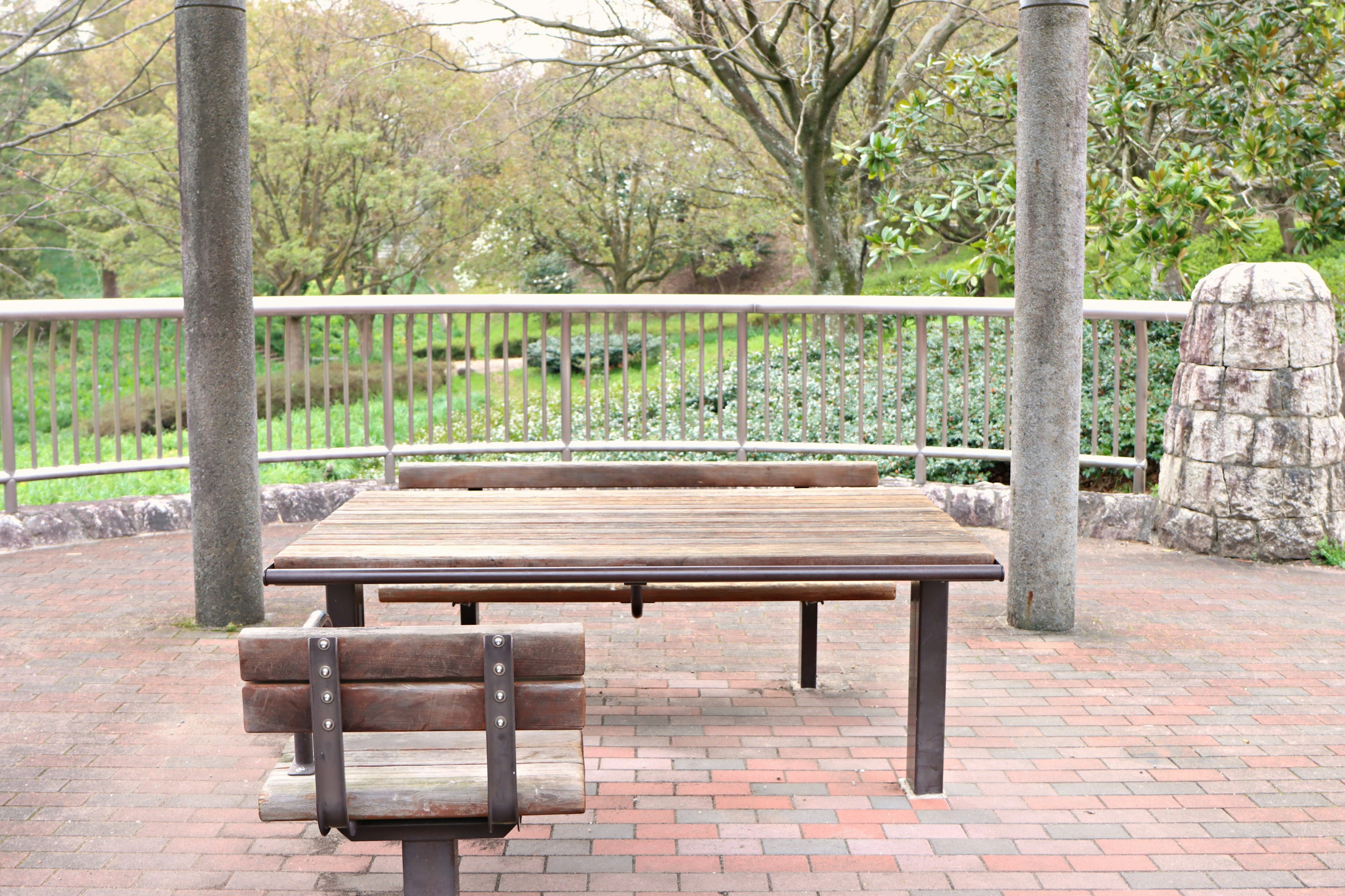 Holztisch und Bank unter einer Pergola in einem Park