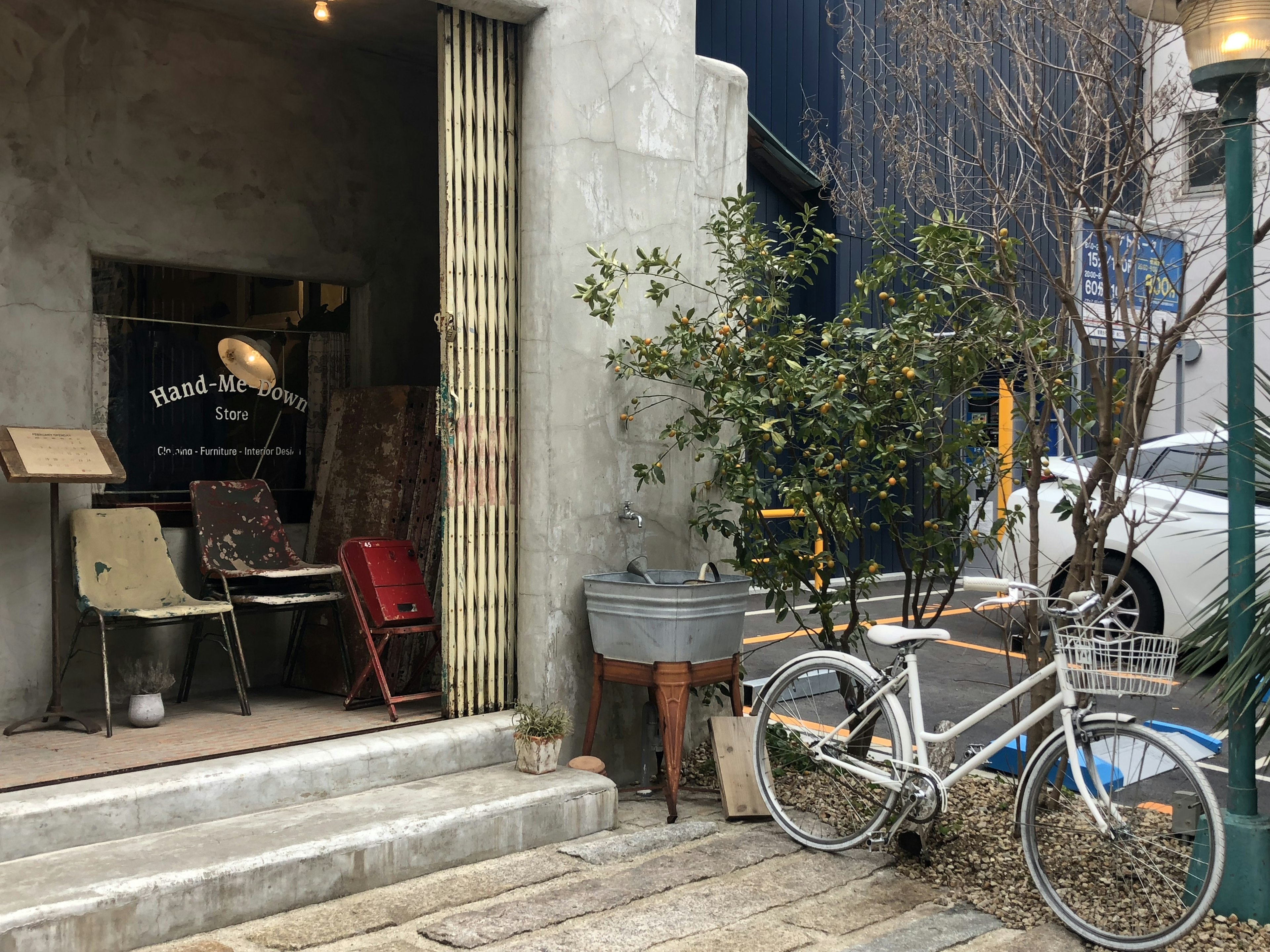 コンクリートの壁の前にあるカフェの外観と自転車の風景