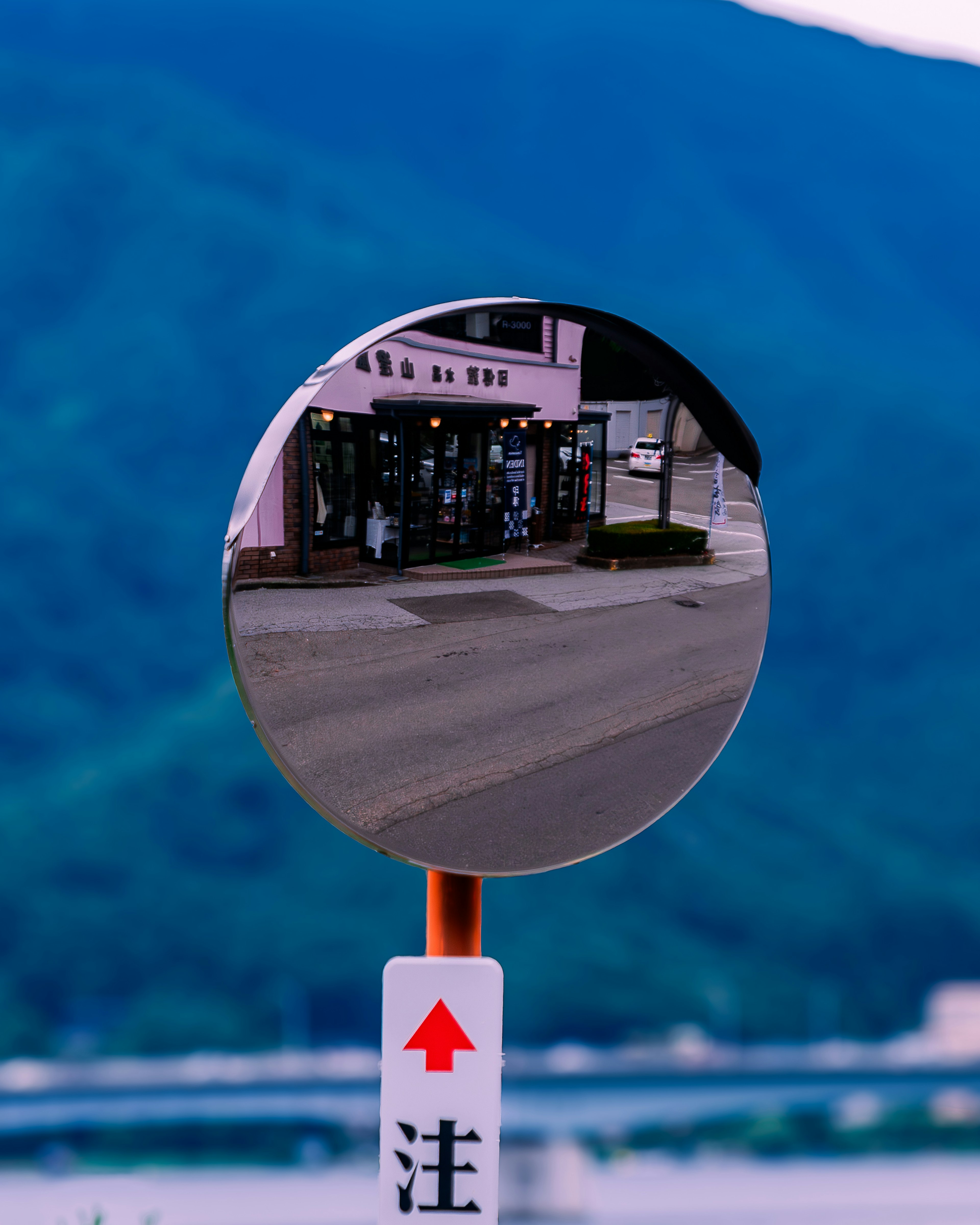 Miroir réfléchissant montrant un magasin et un paysage montagneux