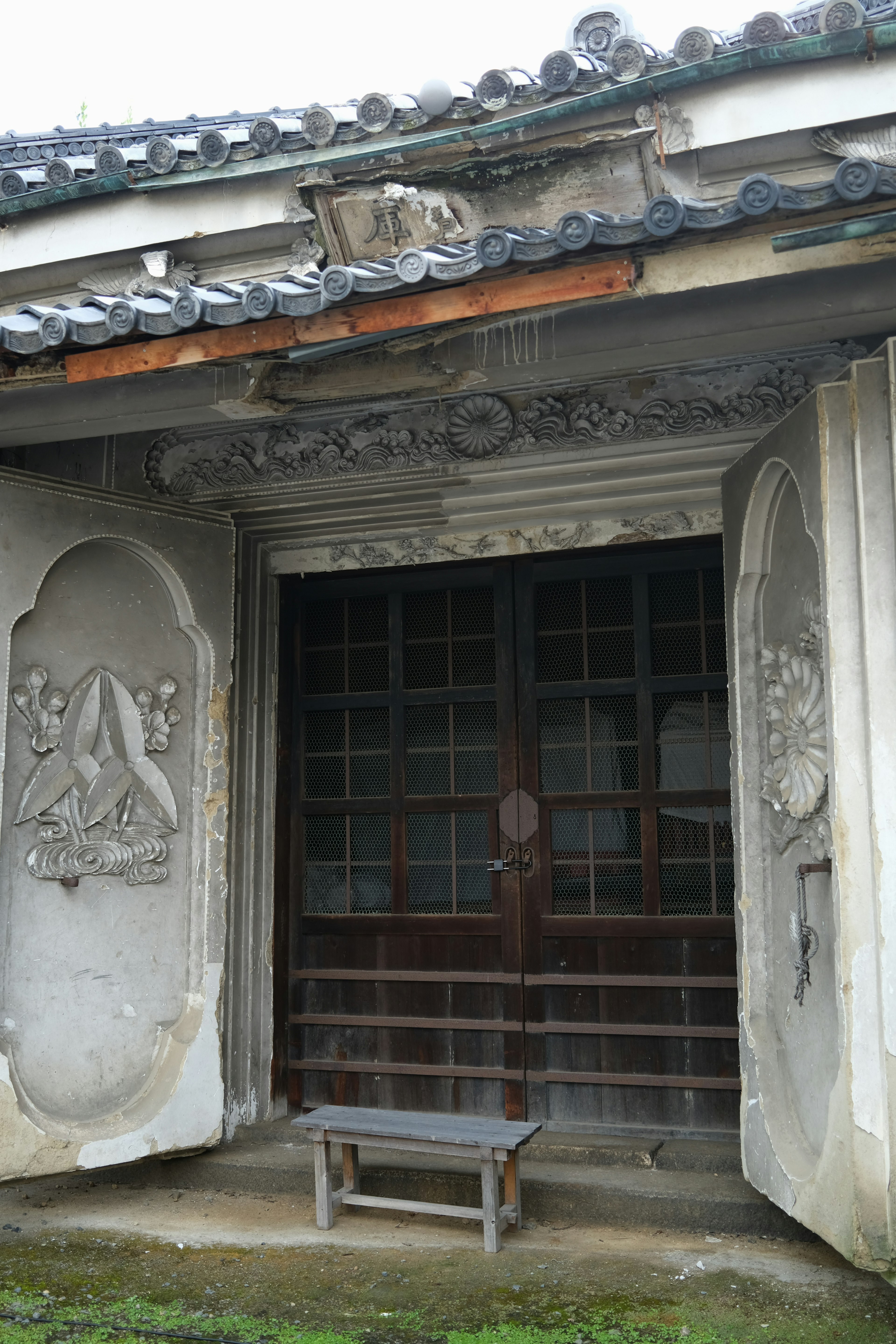 Traditional Japanese building entrance featuring wooden doors and intricate carvings