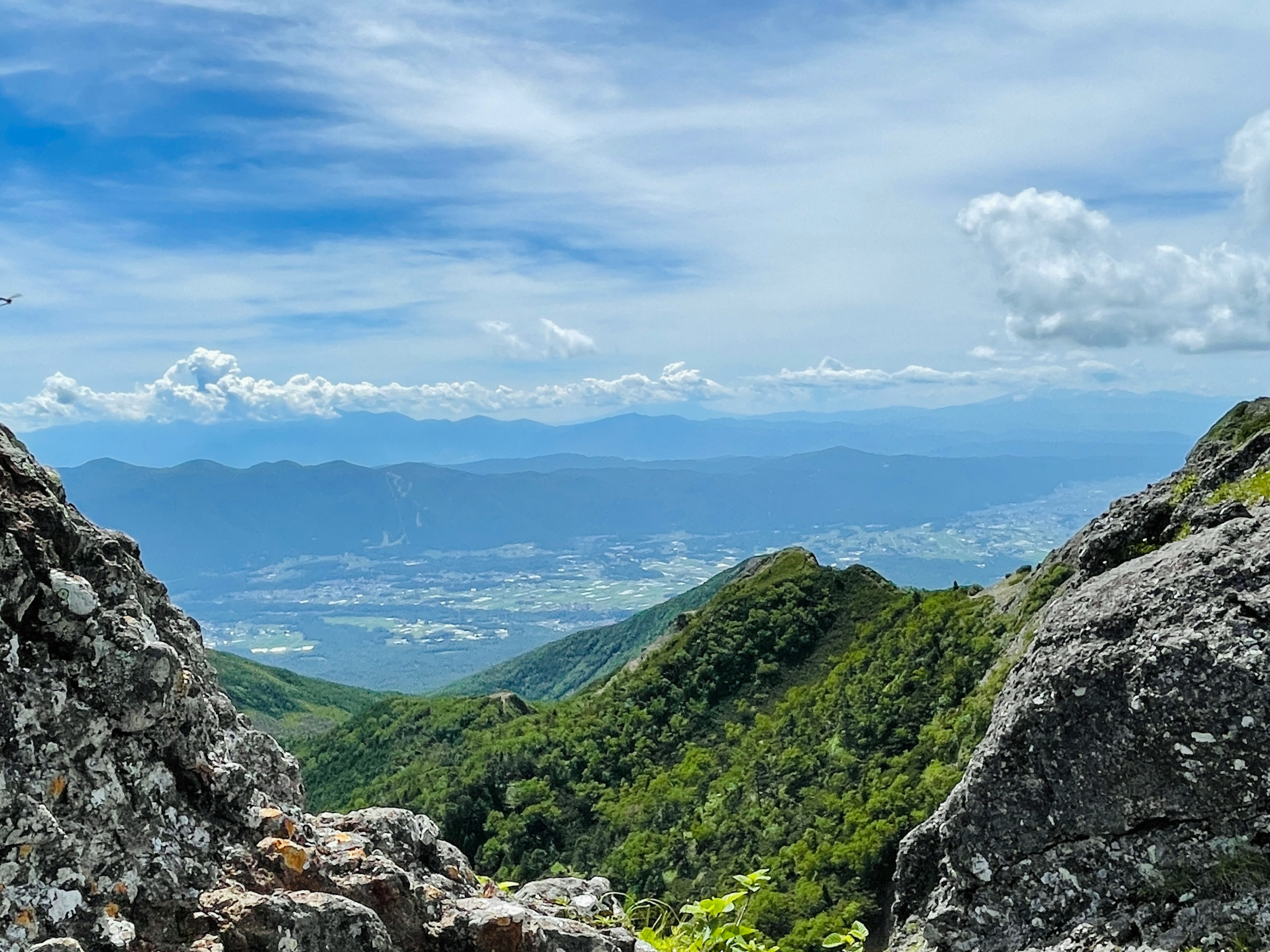 Scenic view between mountains with lush greenery and blue sky