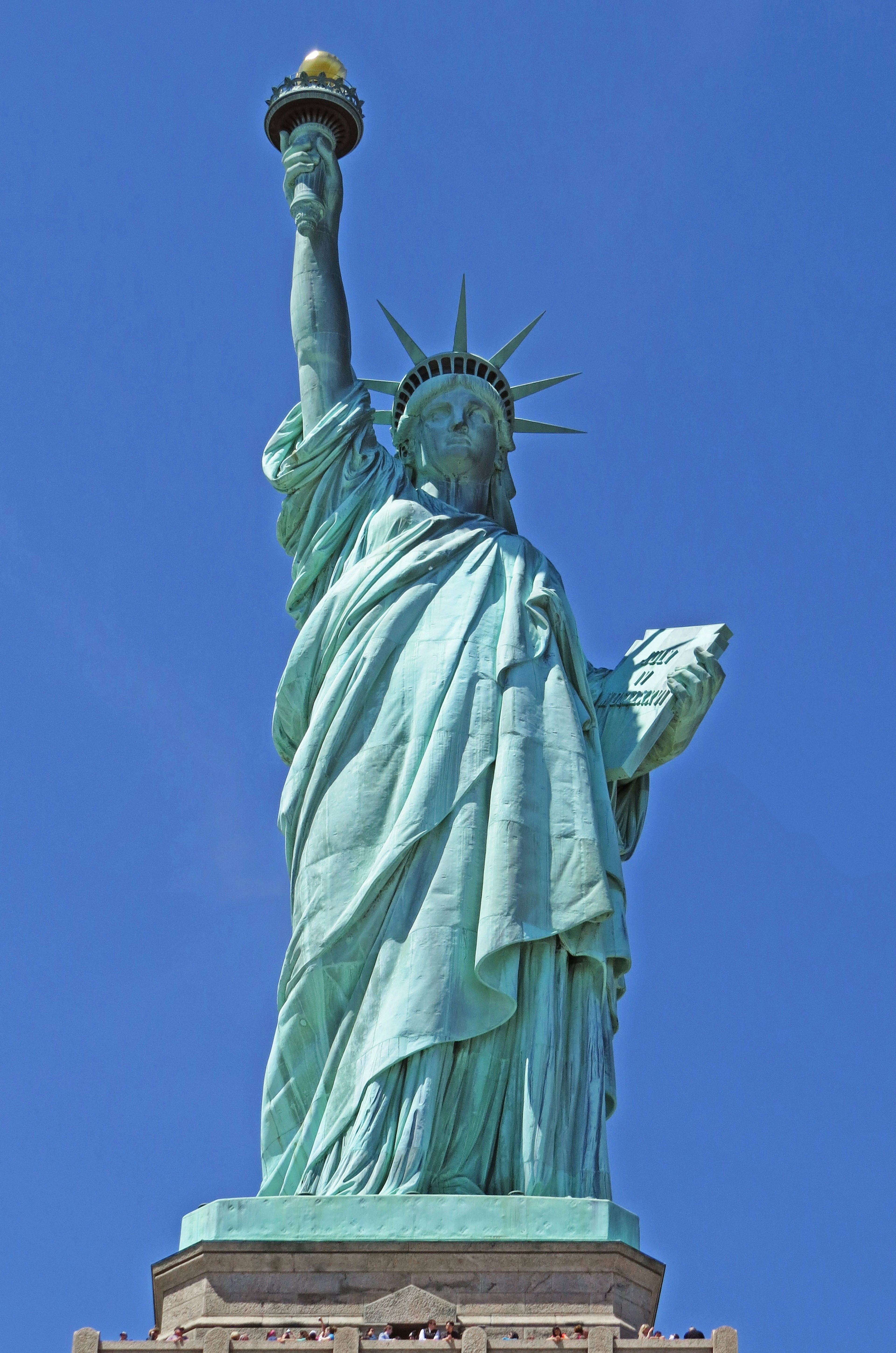 Statue of Liberty standing under a blue sky