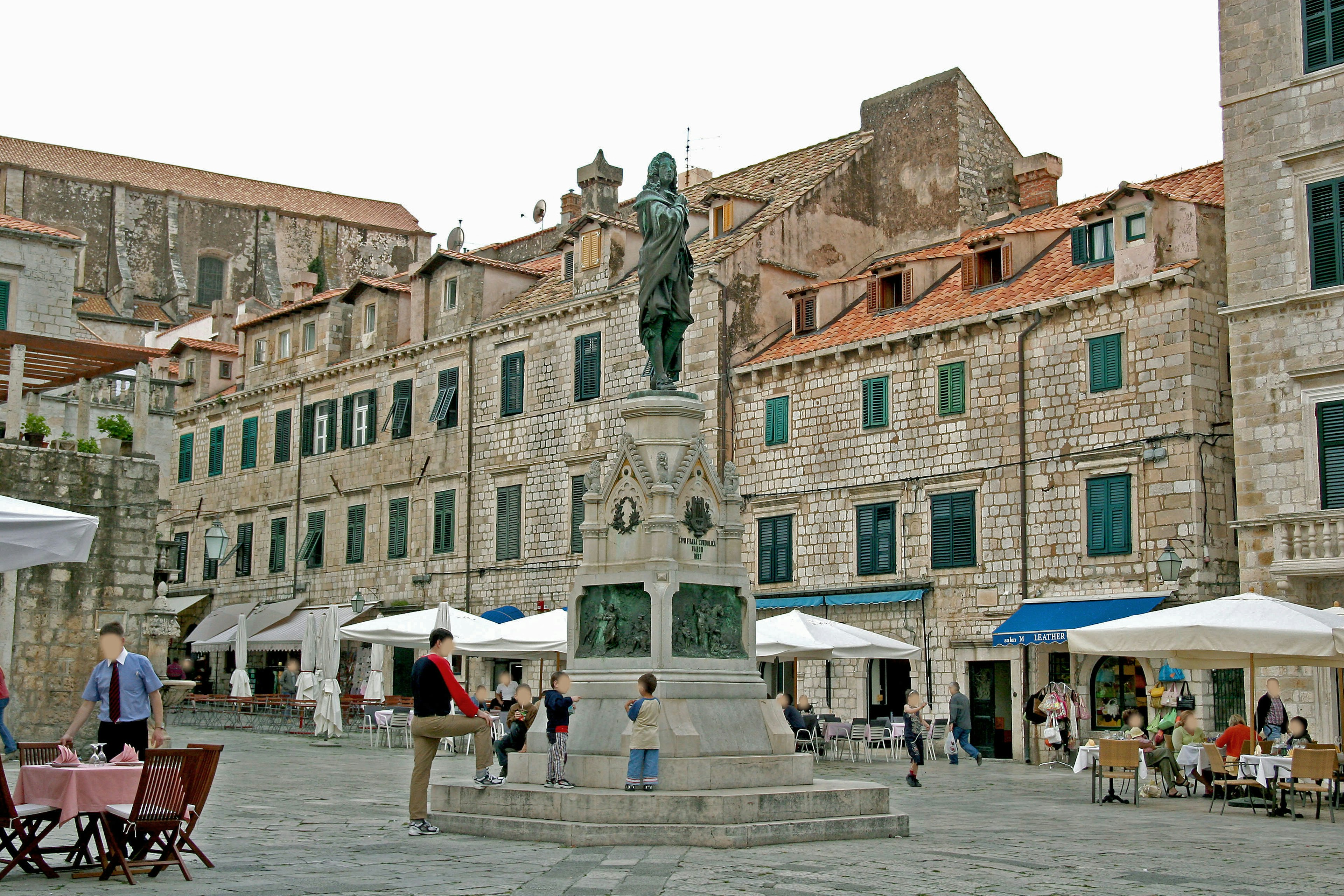 Square with a statue and historic buildings in the background