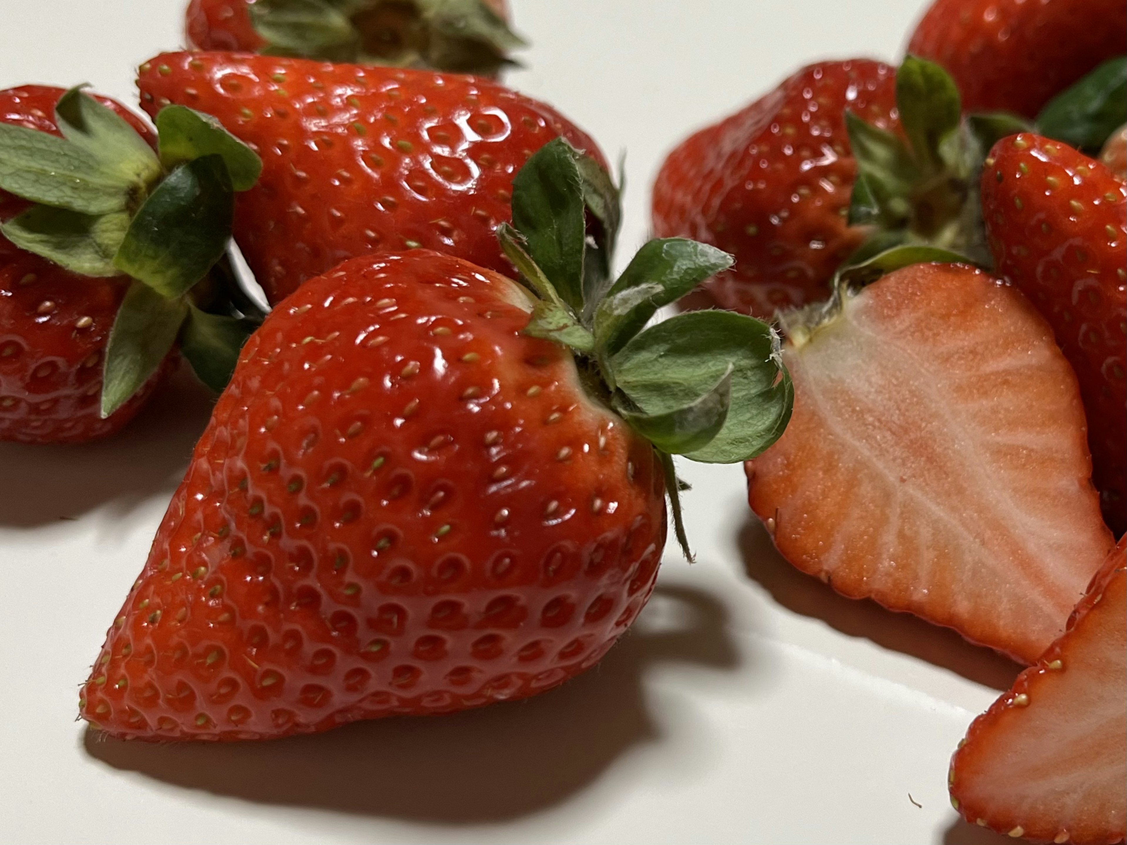 Close-up of fresh strawberries with sliced pieces