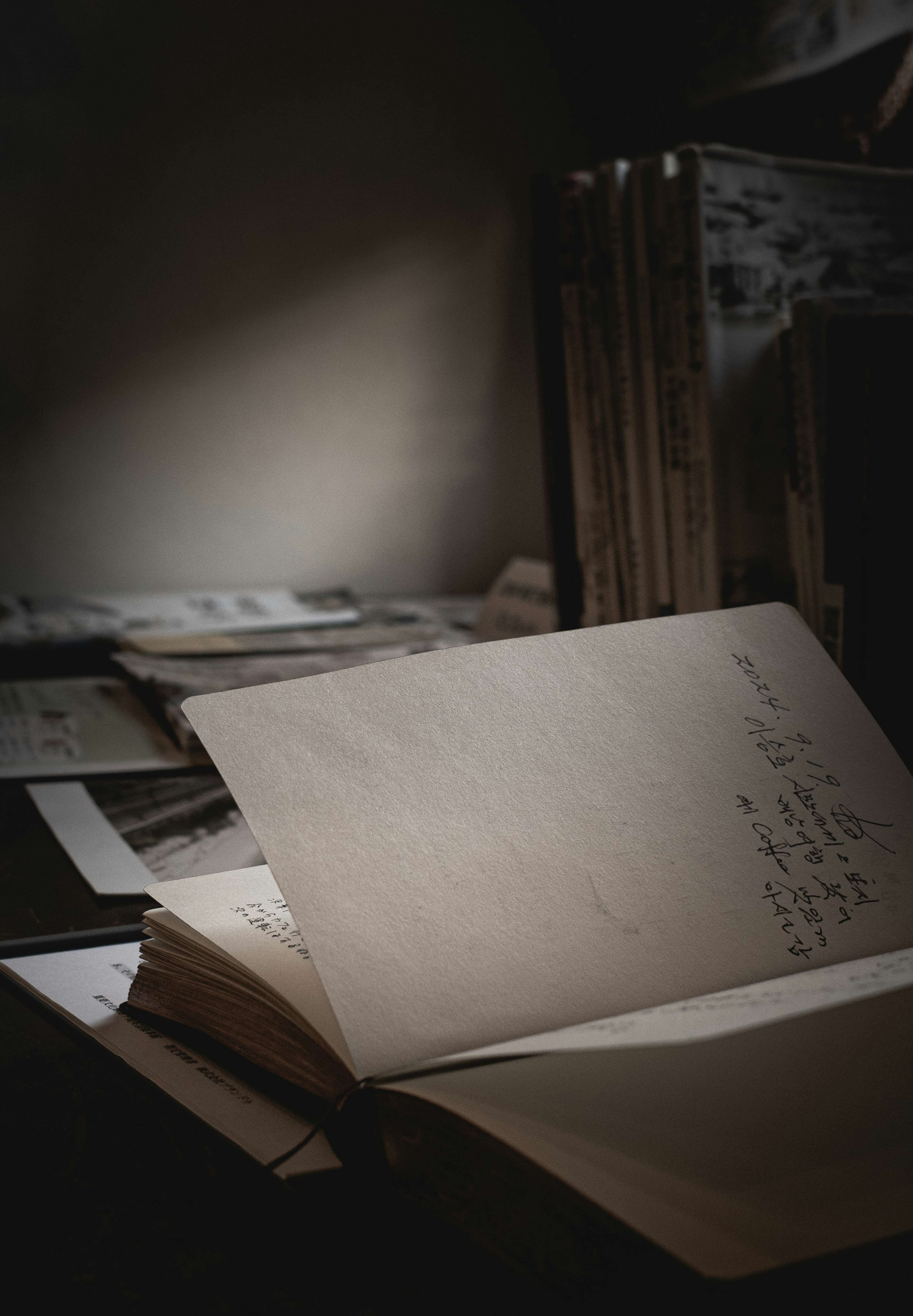 A quiet scene with an open book and old pages in a dark background