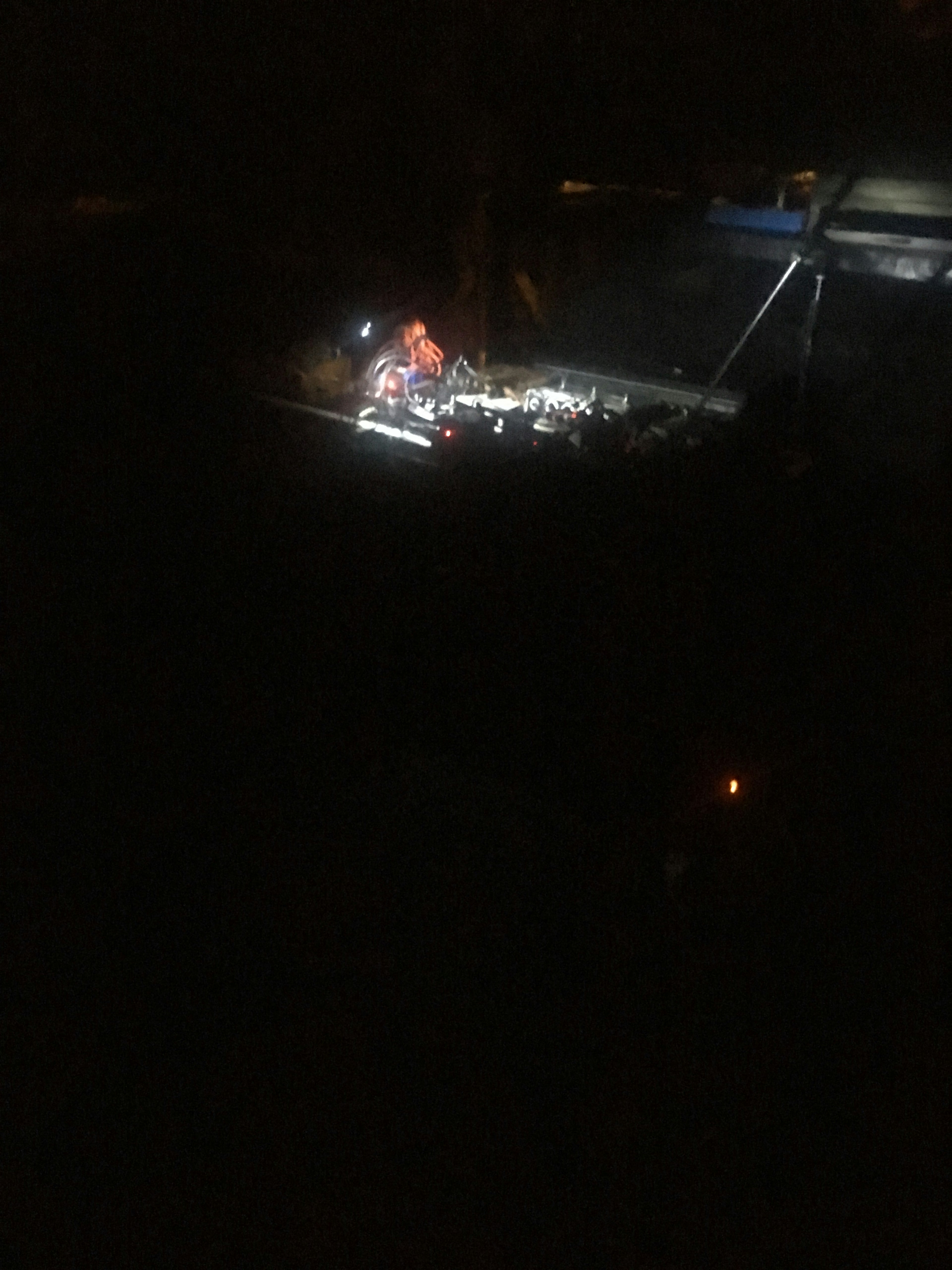 Worker illuminated by lights at a construction site during night