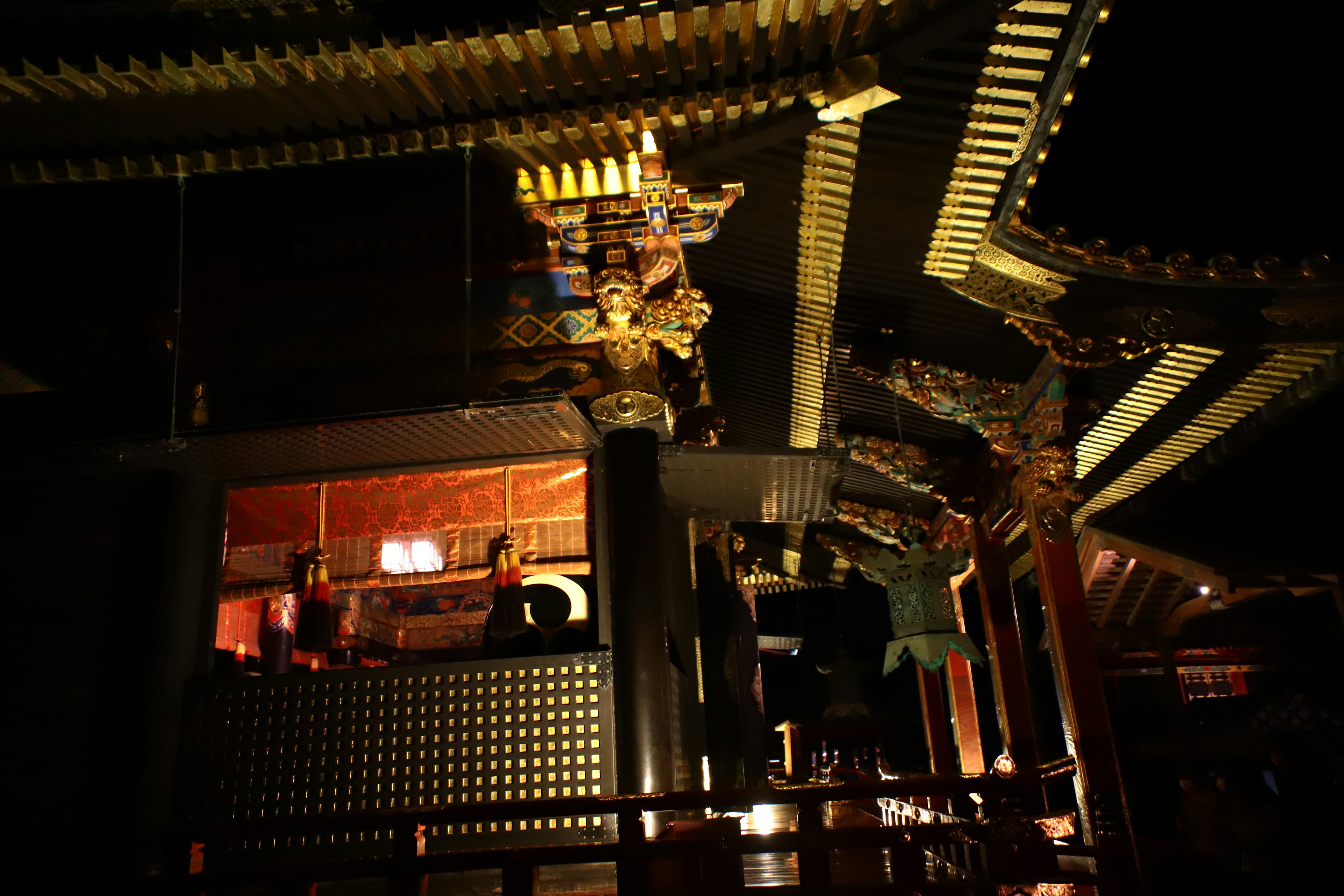 Illuminated shrine architecture with intricate decorations at night