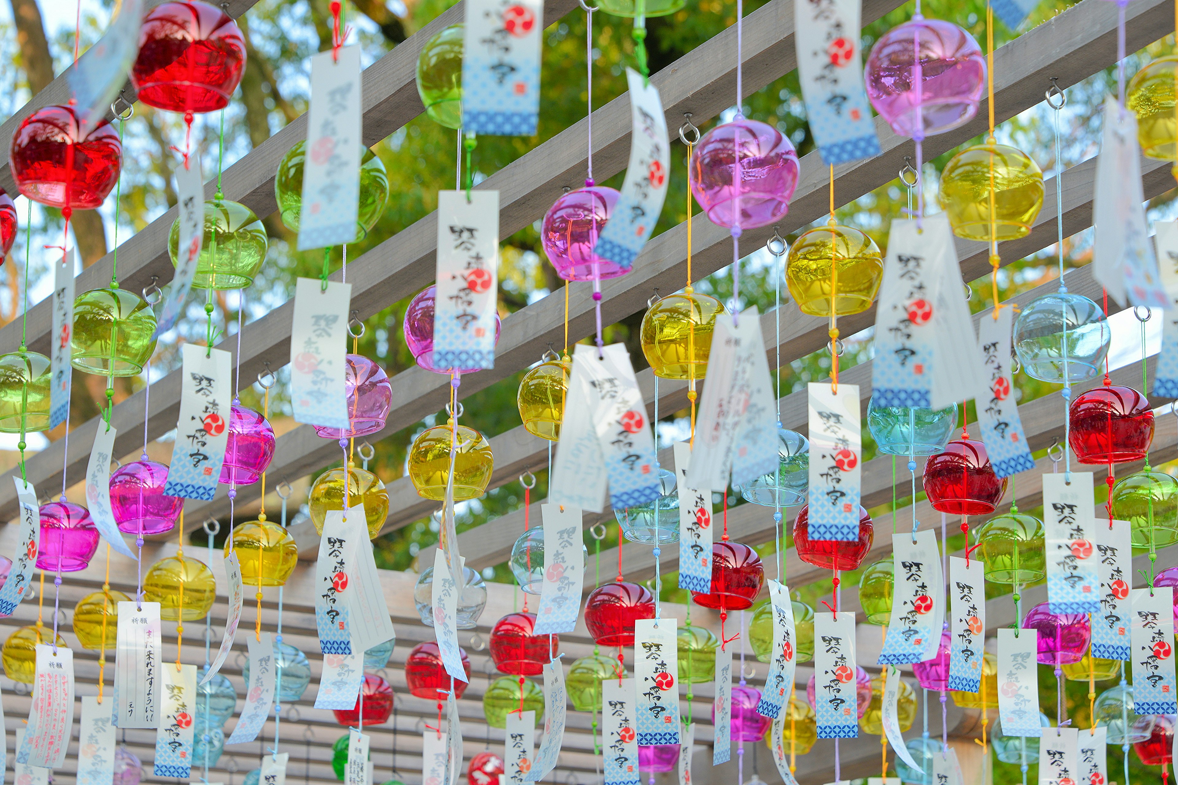 Colorful wind chimes hanging in an outdoor setting