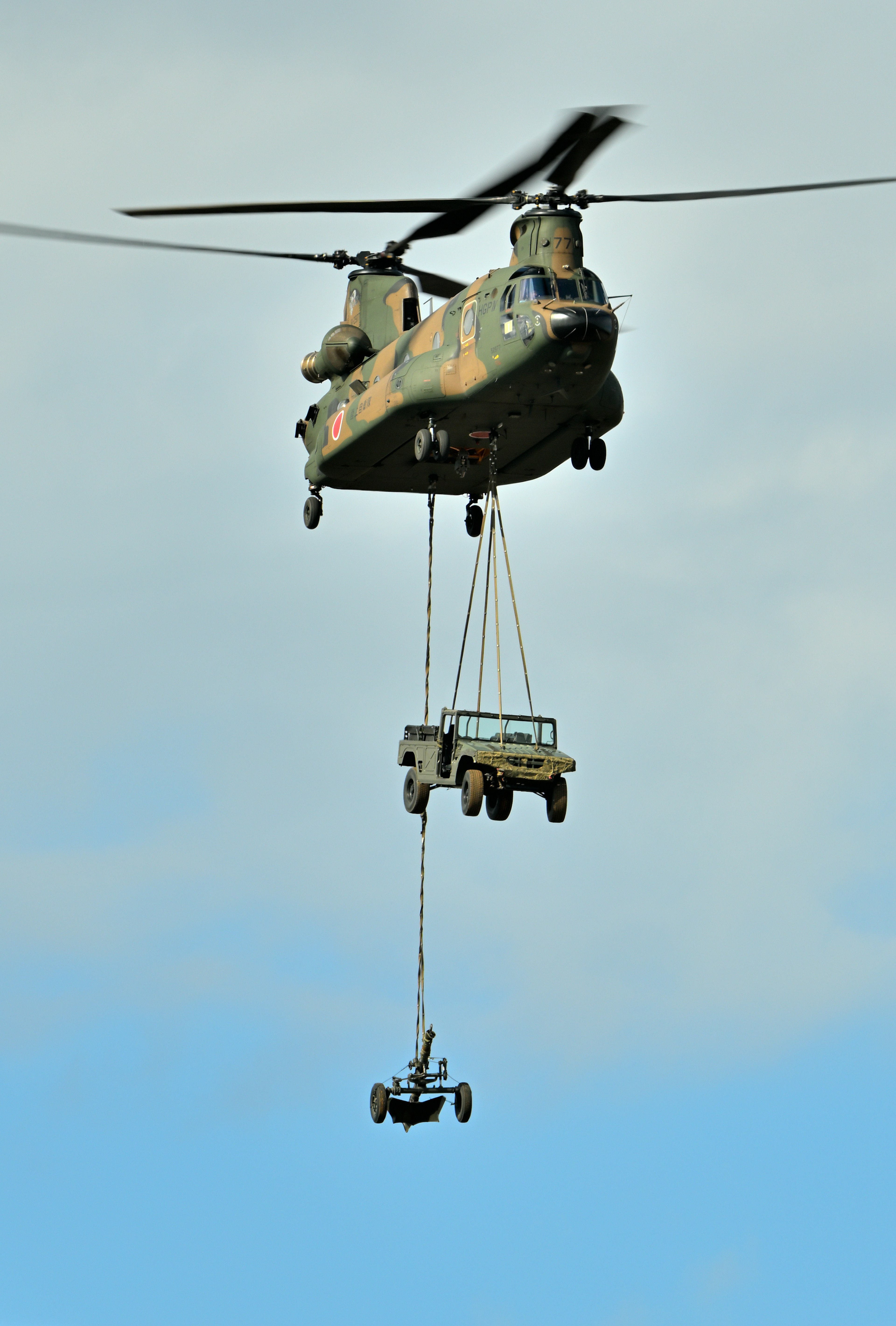 Military helicopter lifting vehicle with cargo hooks