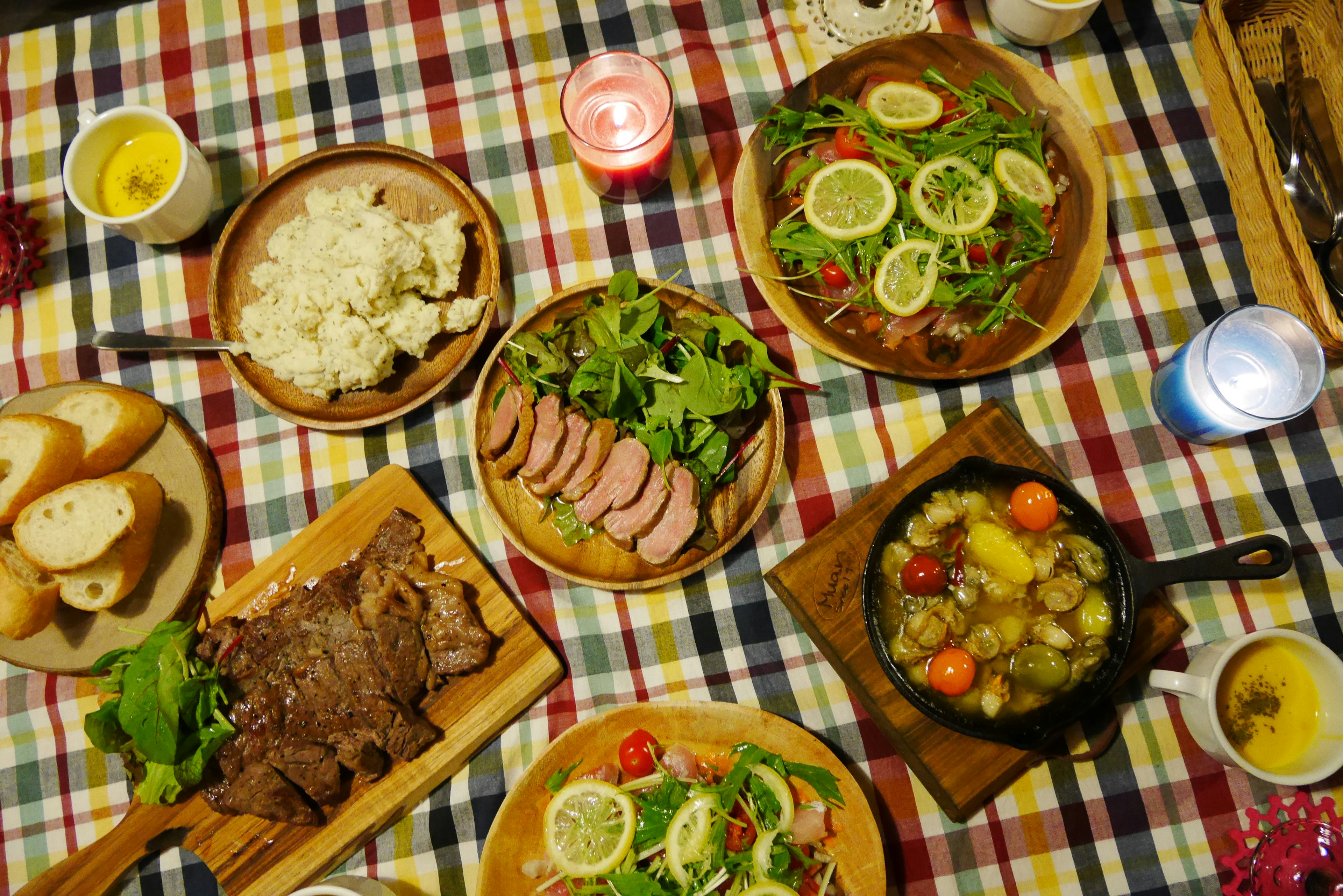 A variety of dishes arranged on a table with a colorful tablecloth