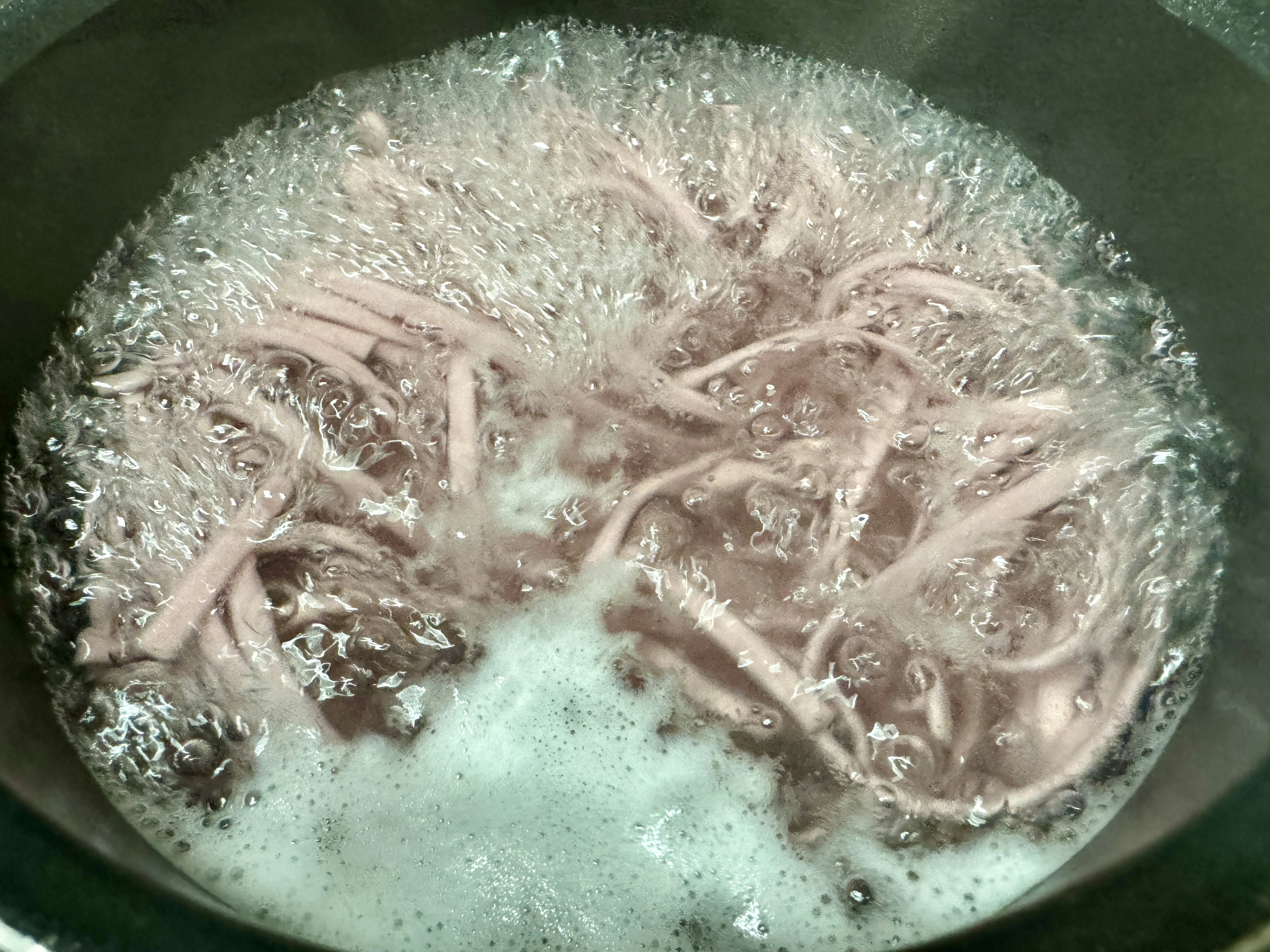 Boiling spaghetti in a pot with bubbles and water