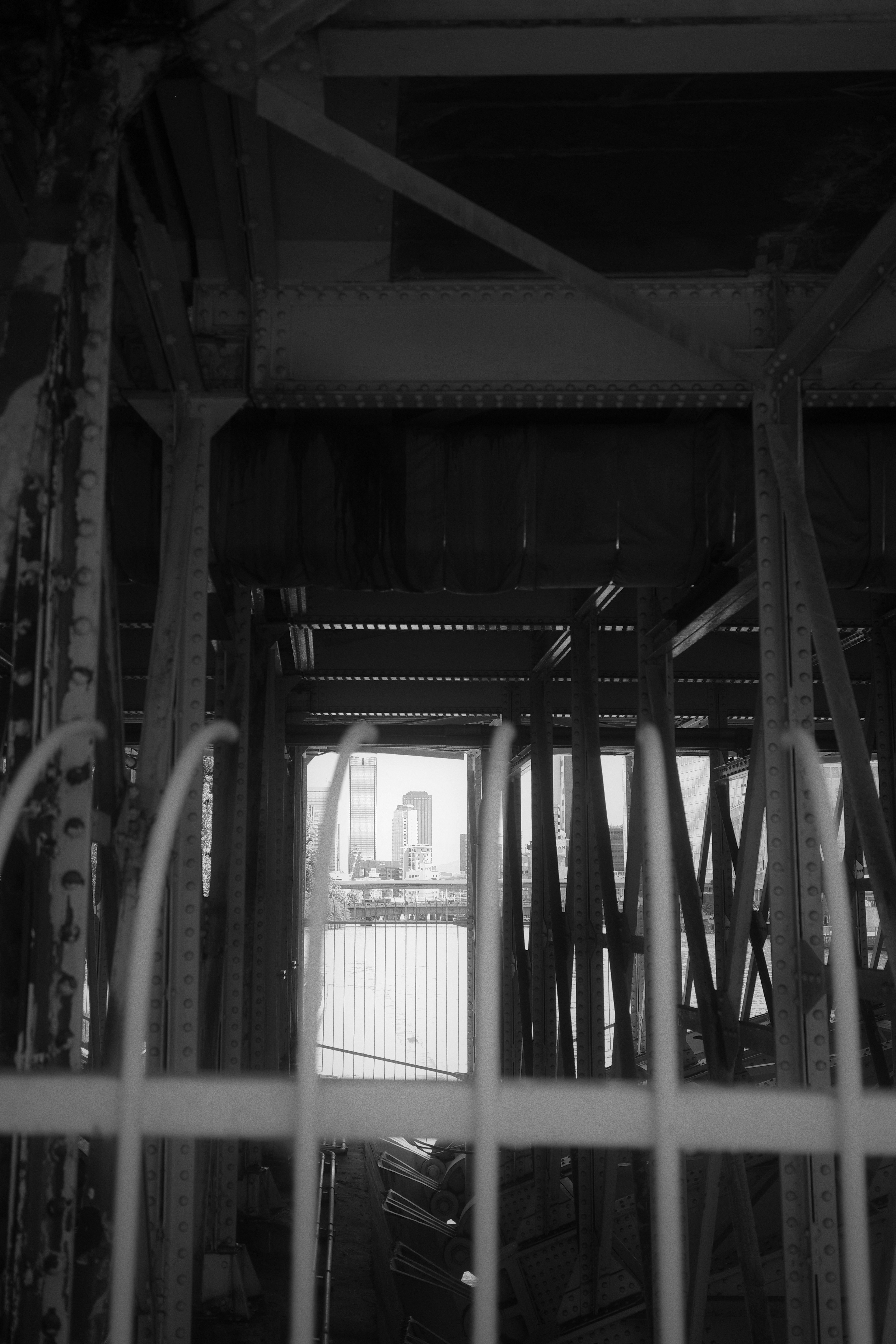 Black and white view of a building structure with a reflection on the water