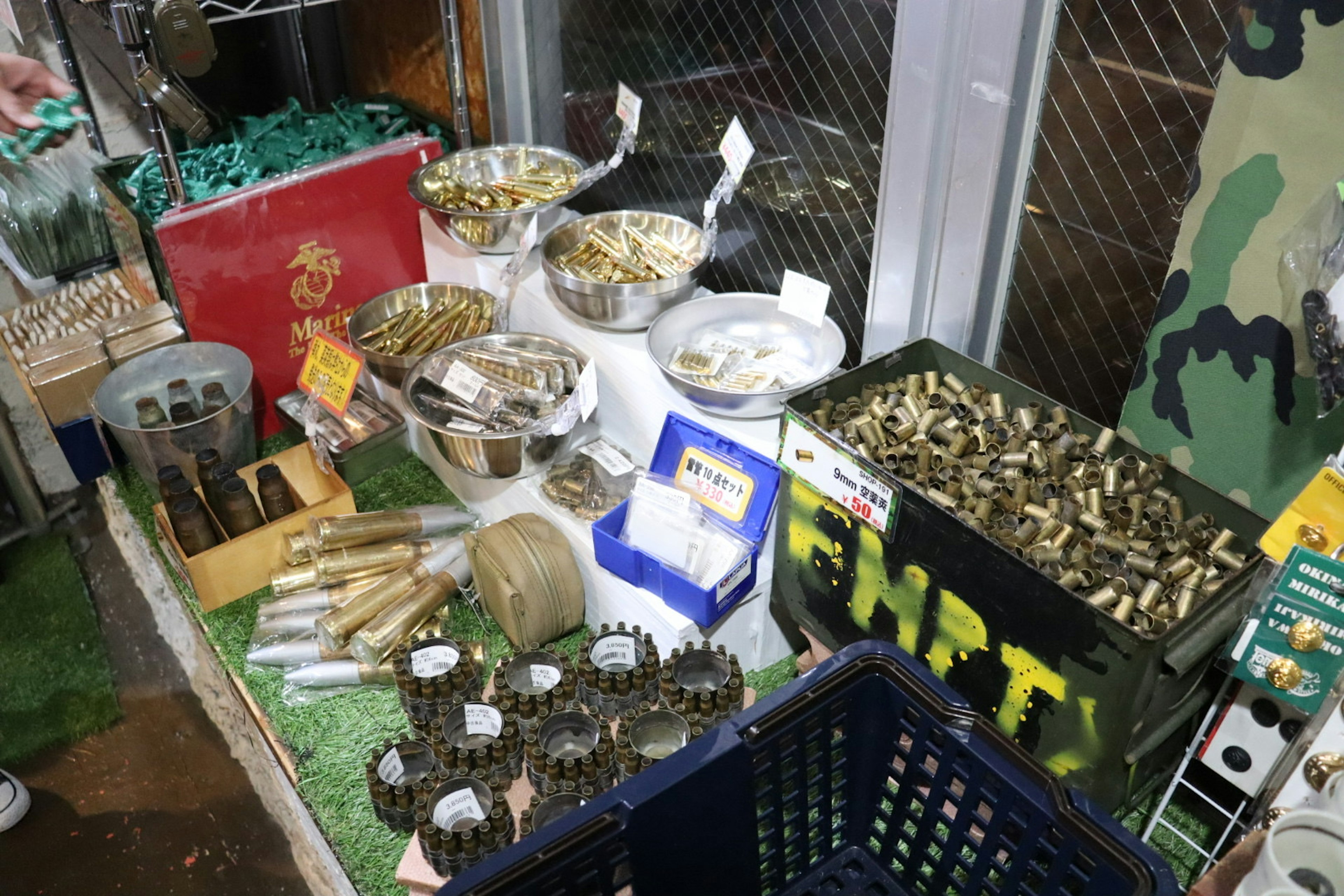 Display of military supplies and ammunition featuring various metal items