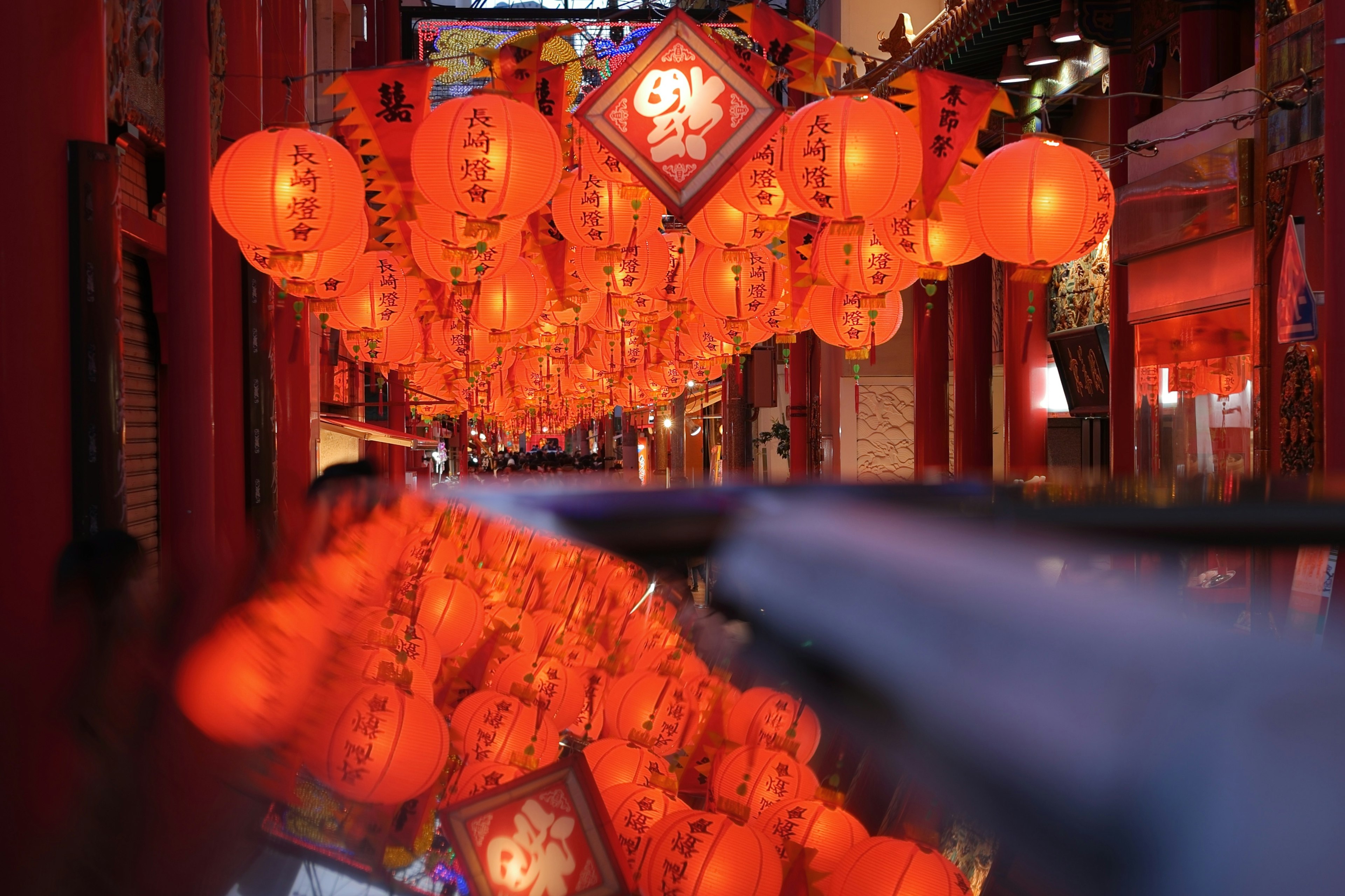 Street scene with red lanterns hanging overhead