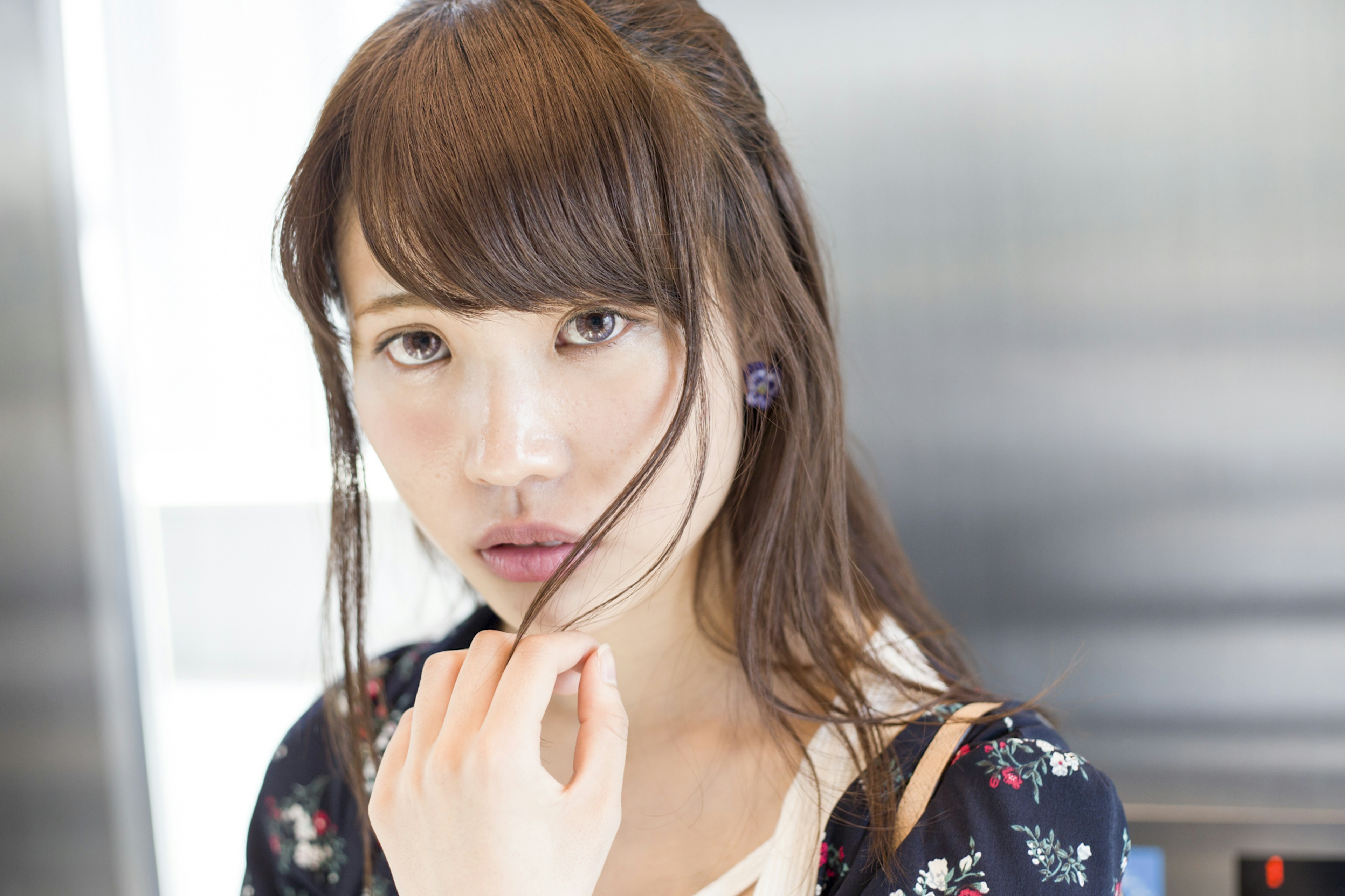 Portrait of a woman deep in thought against a modern background