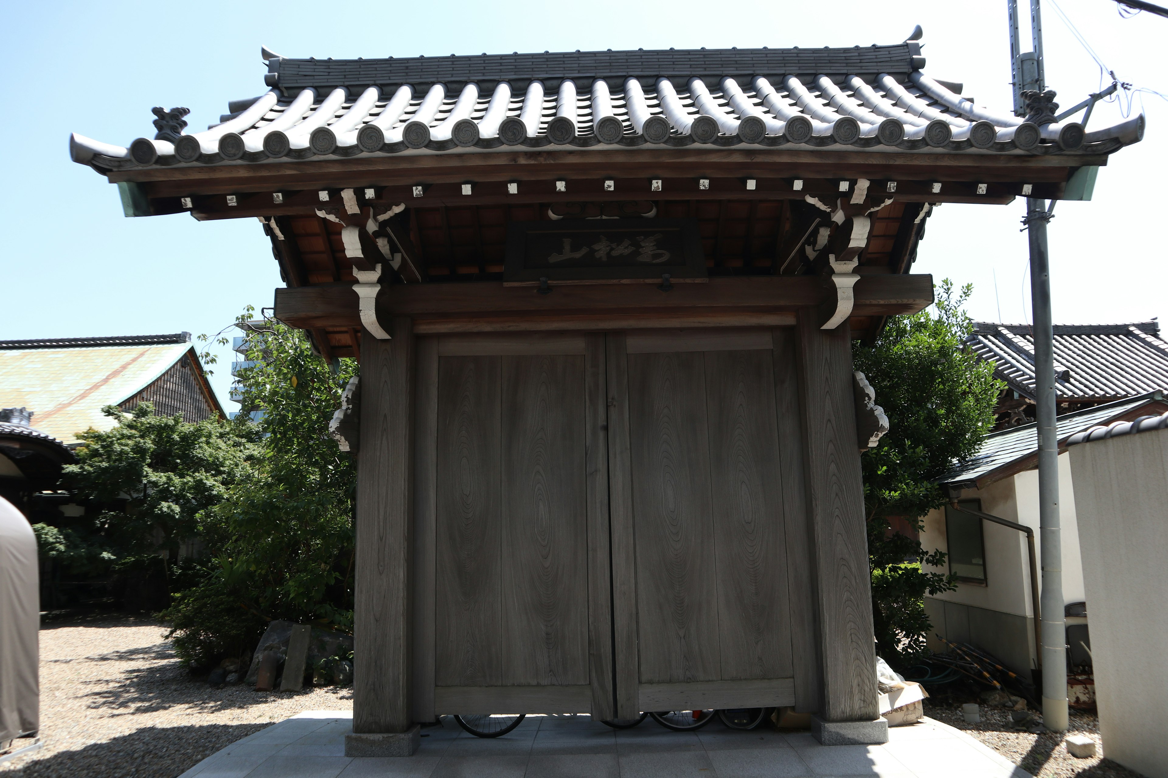 Traditional Japanese gate structure with tiled roof design