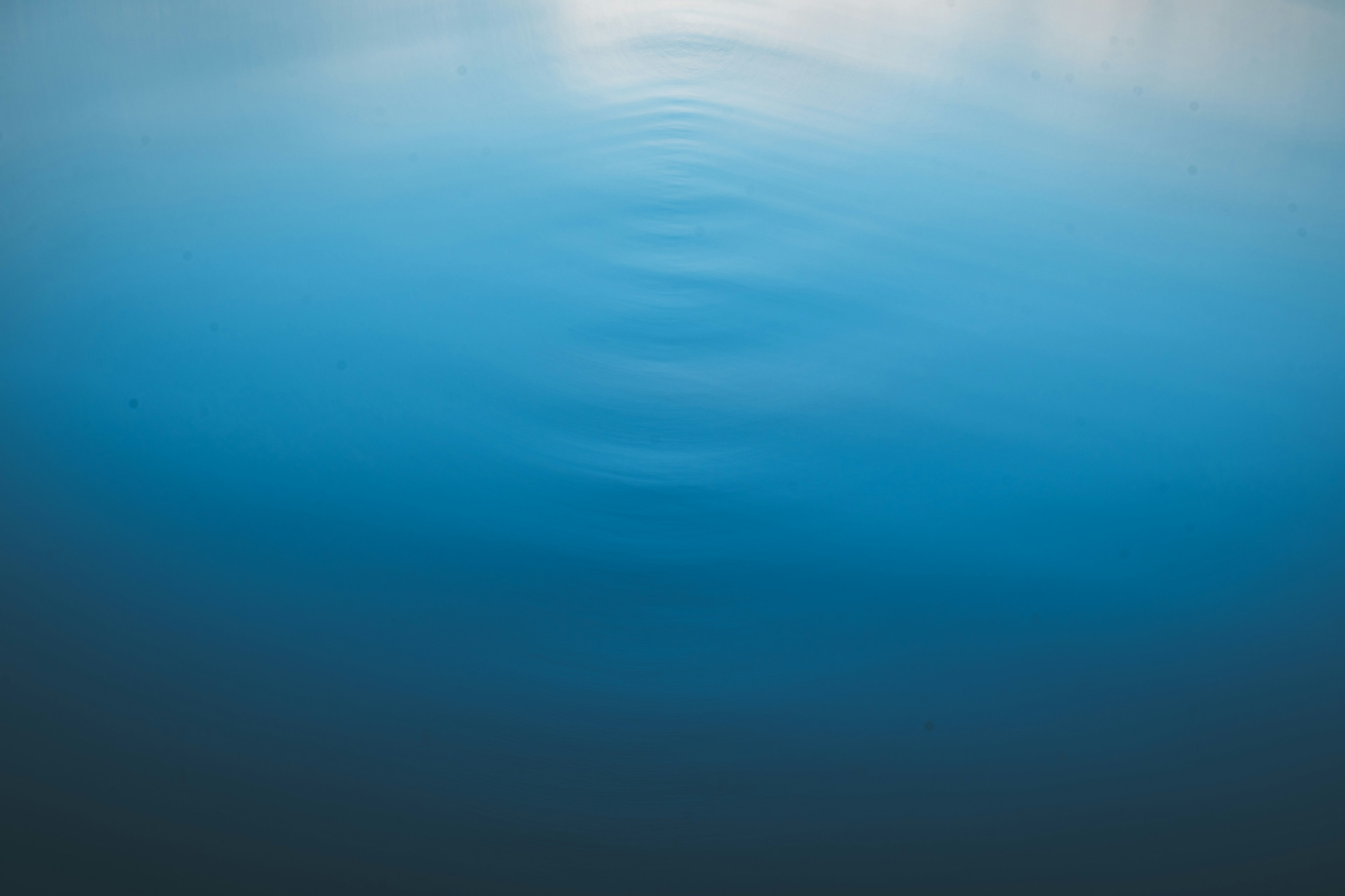 Rippling blue water surface with reflections