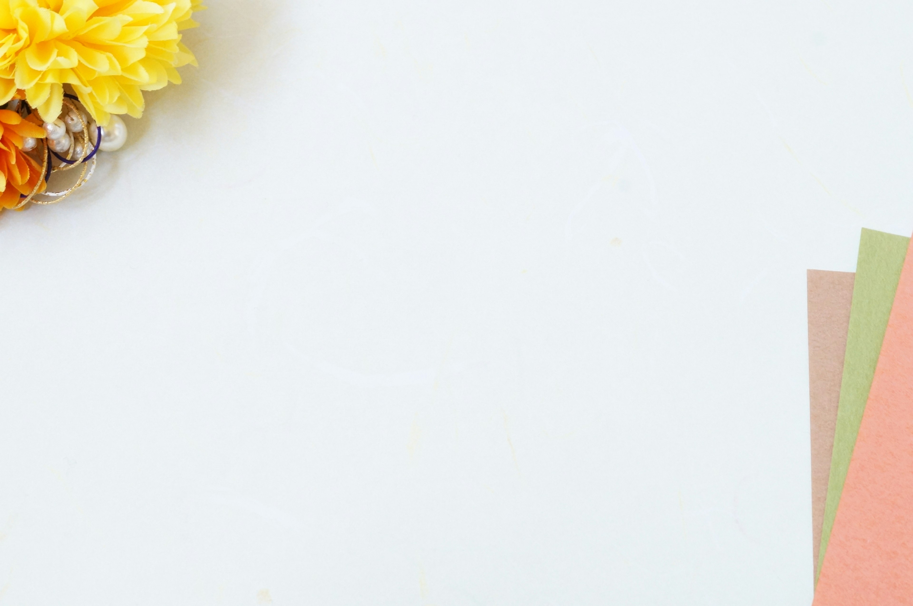 Image featuring colorful paper and a yellow flower on a white background