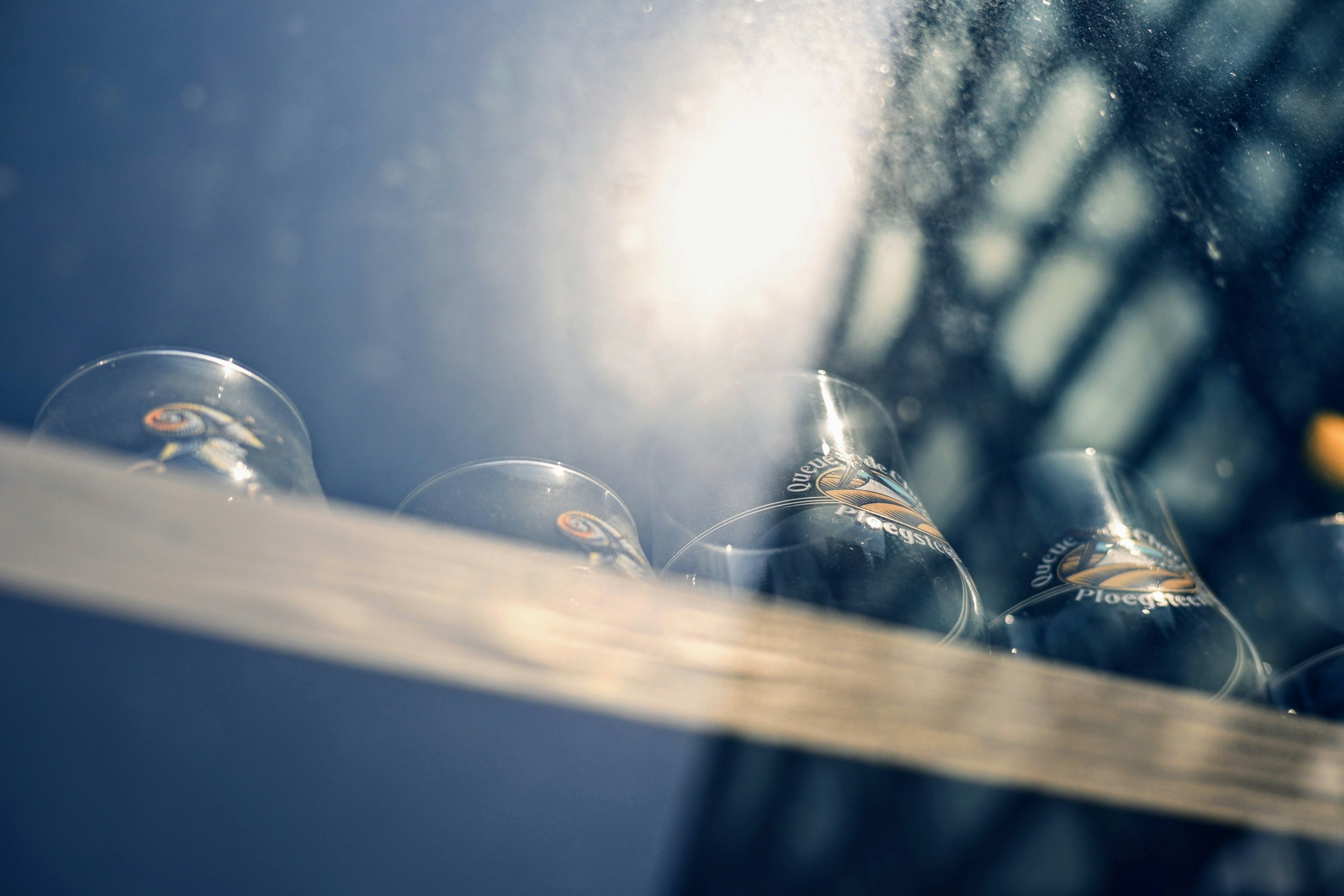 Photo of glass vessels lined up on a windowsill illuminated by light