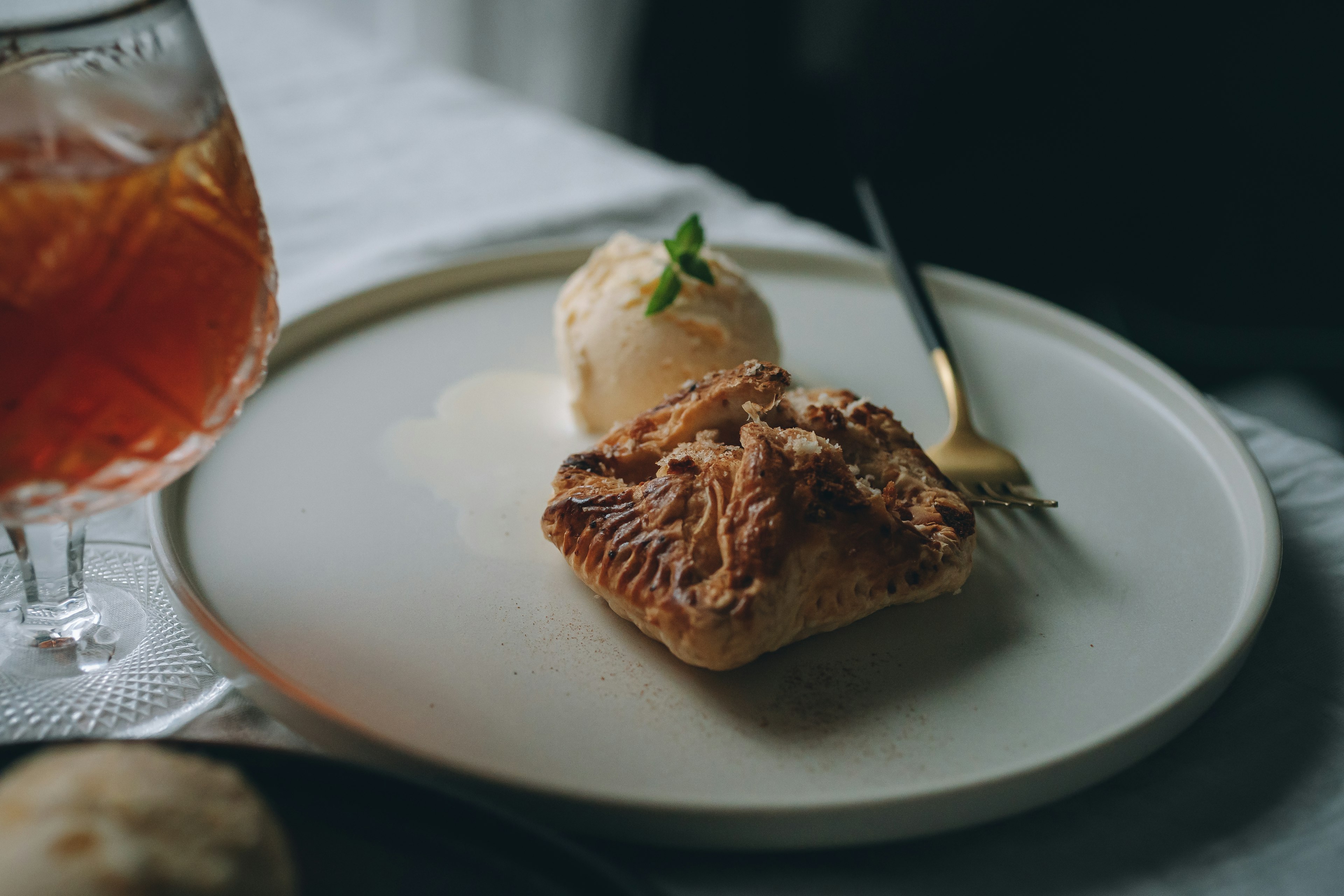 A delicious dessert plate featuring ice cream and pastry served elegantly