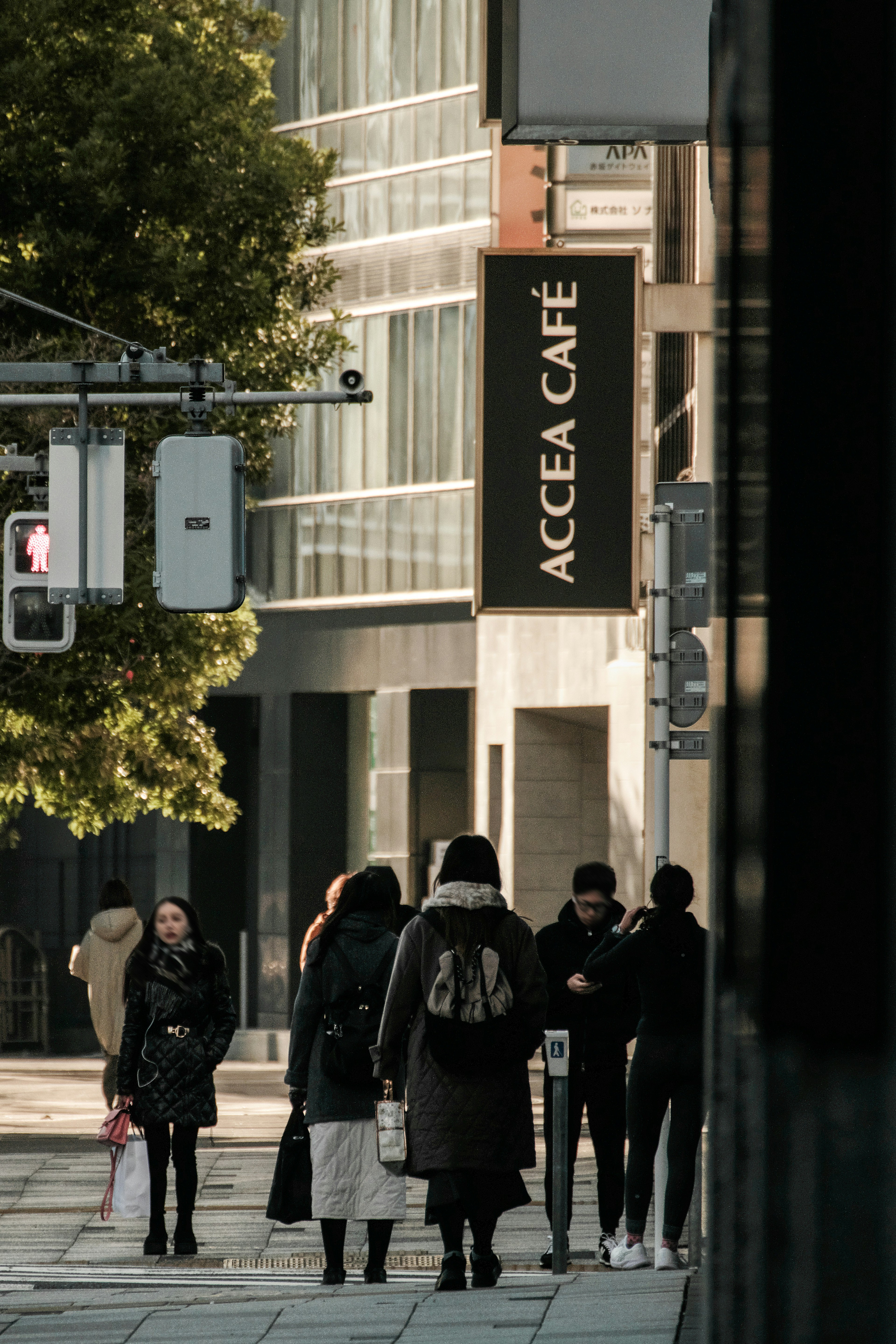 Persone che camminano per strada con il segnale dell'ACCEA CAFÉ visibile