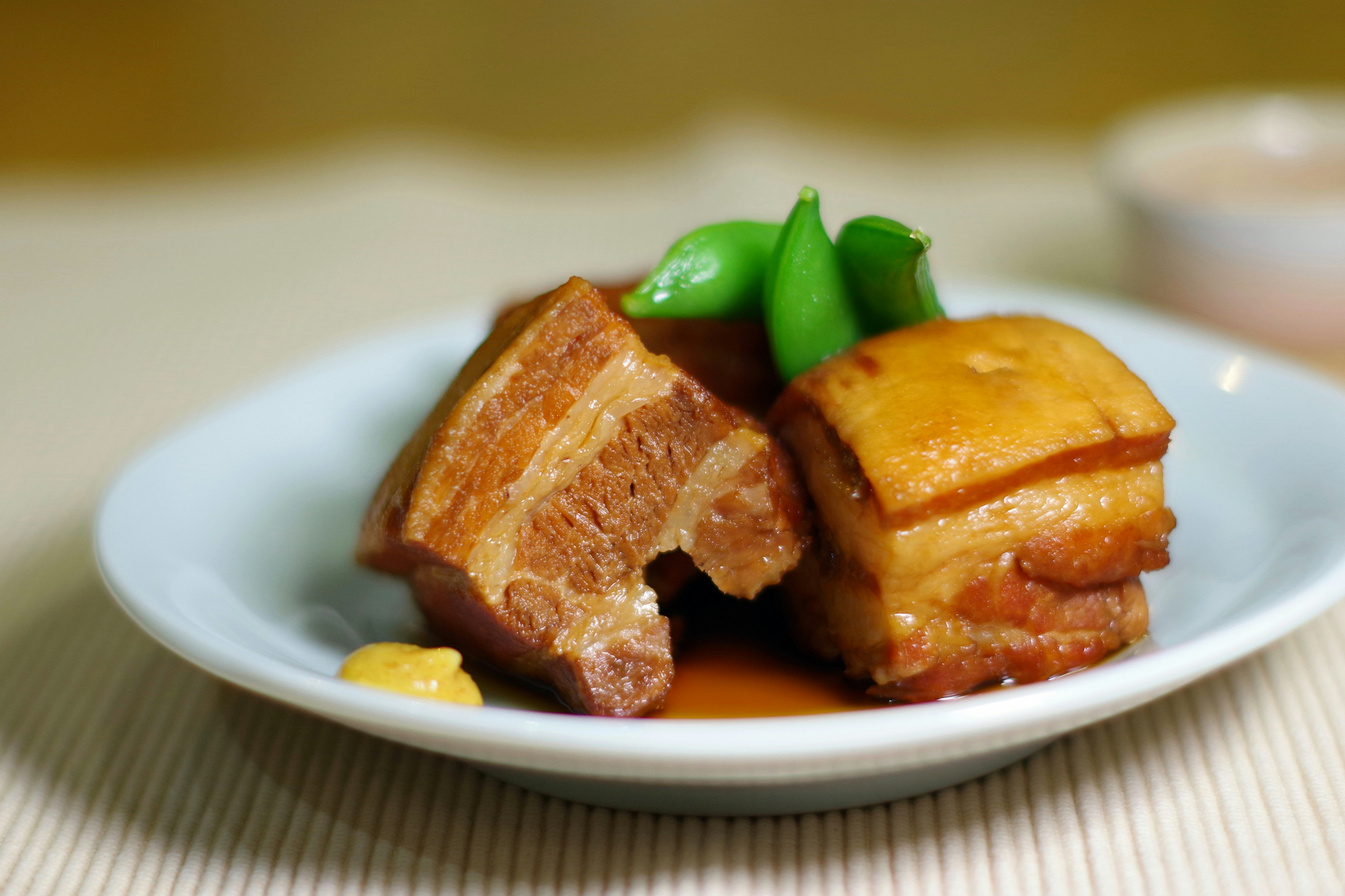 Delicious pork belly dish served on a white plate