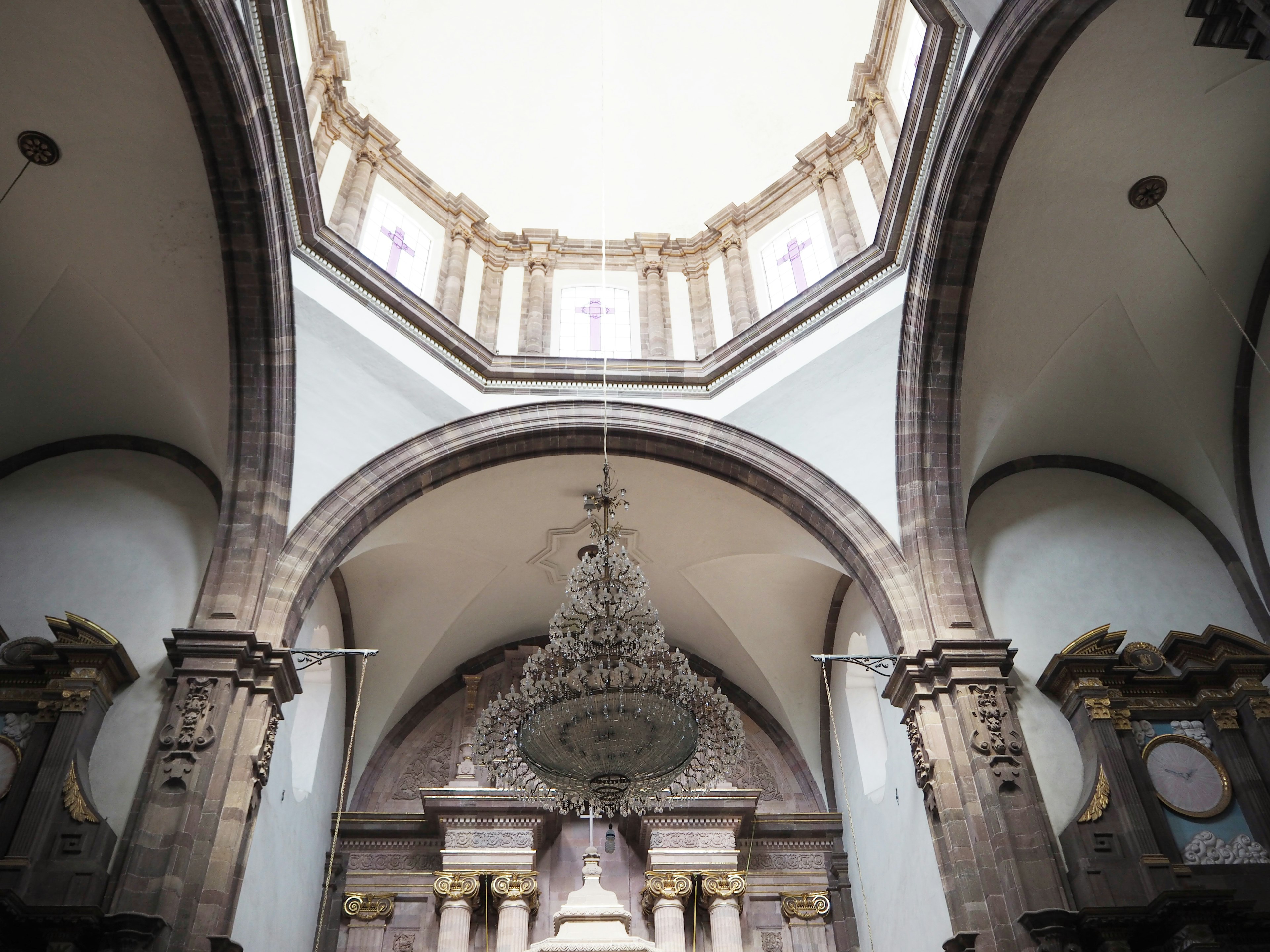 Interior of a church featuring a stunning chandelier and high arched ceiling