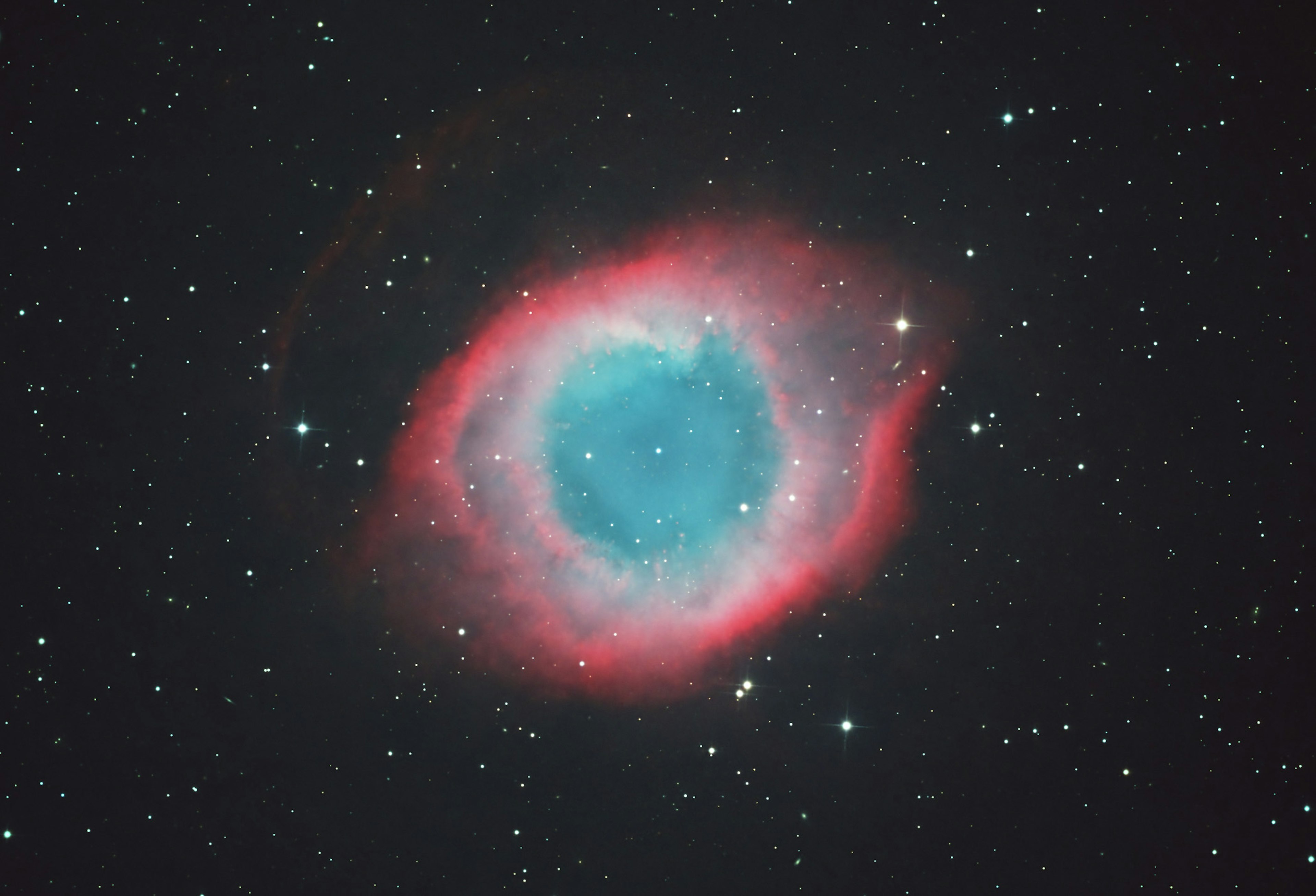 Image of the Helix Nebula featuring vibrant blue and red contours