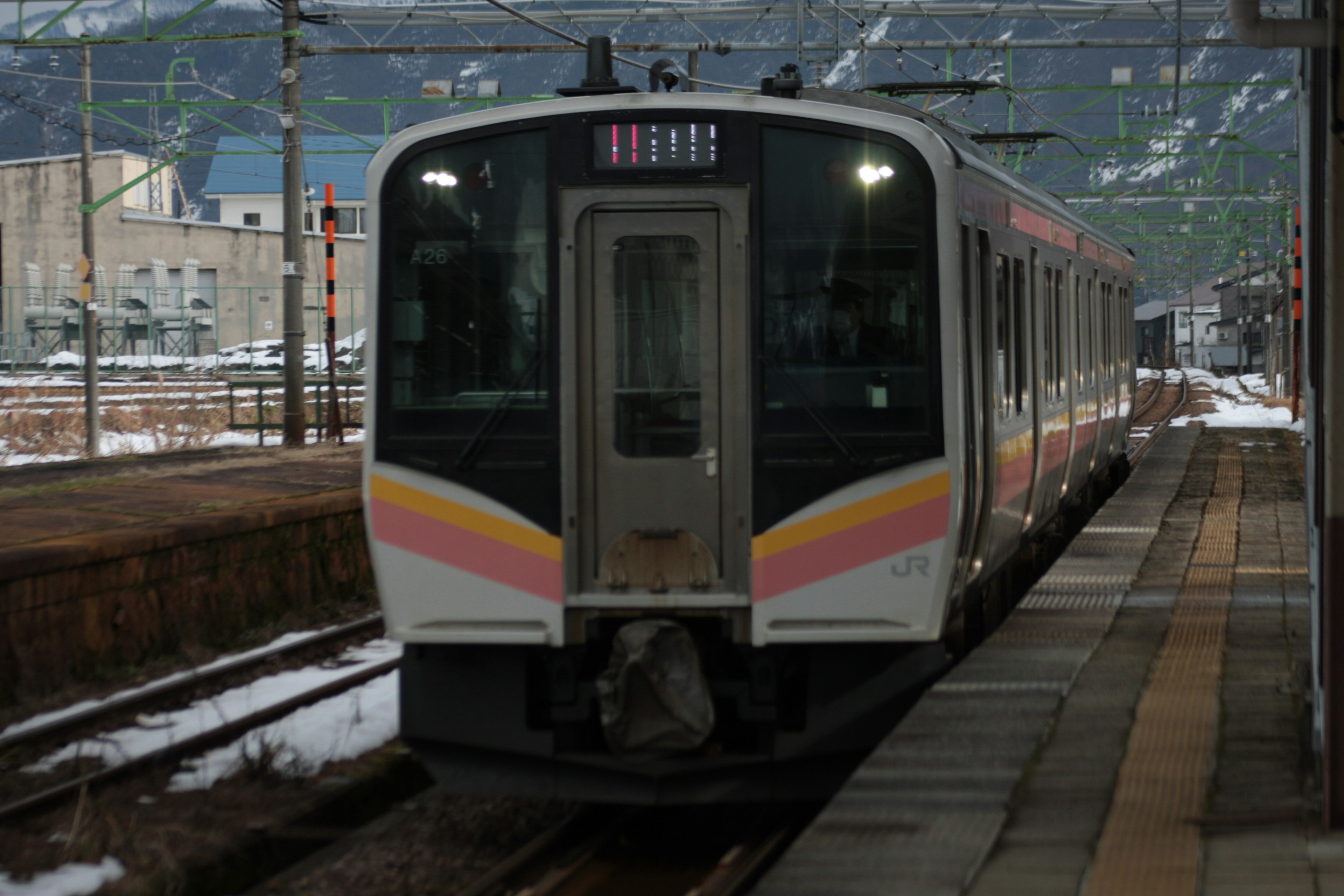 Front view of a train stopped at a snow-covered station