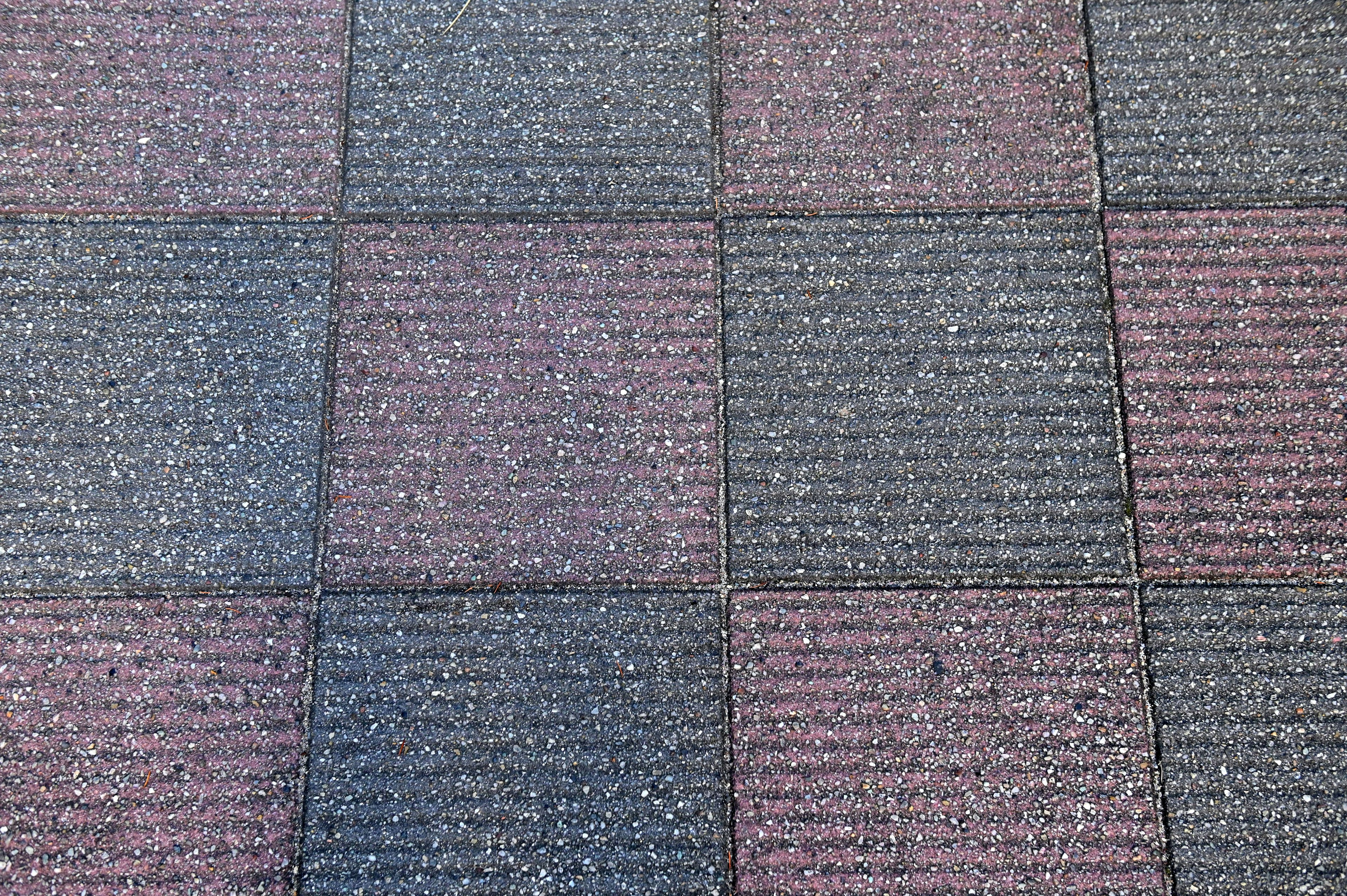 Paved surface with alternating red and gray blocks