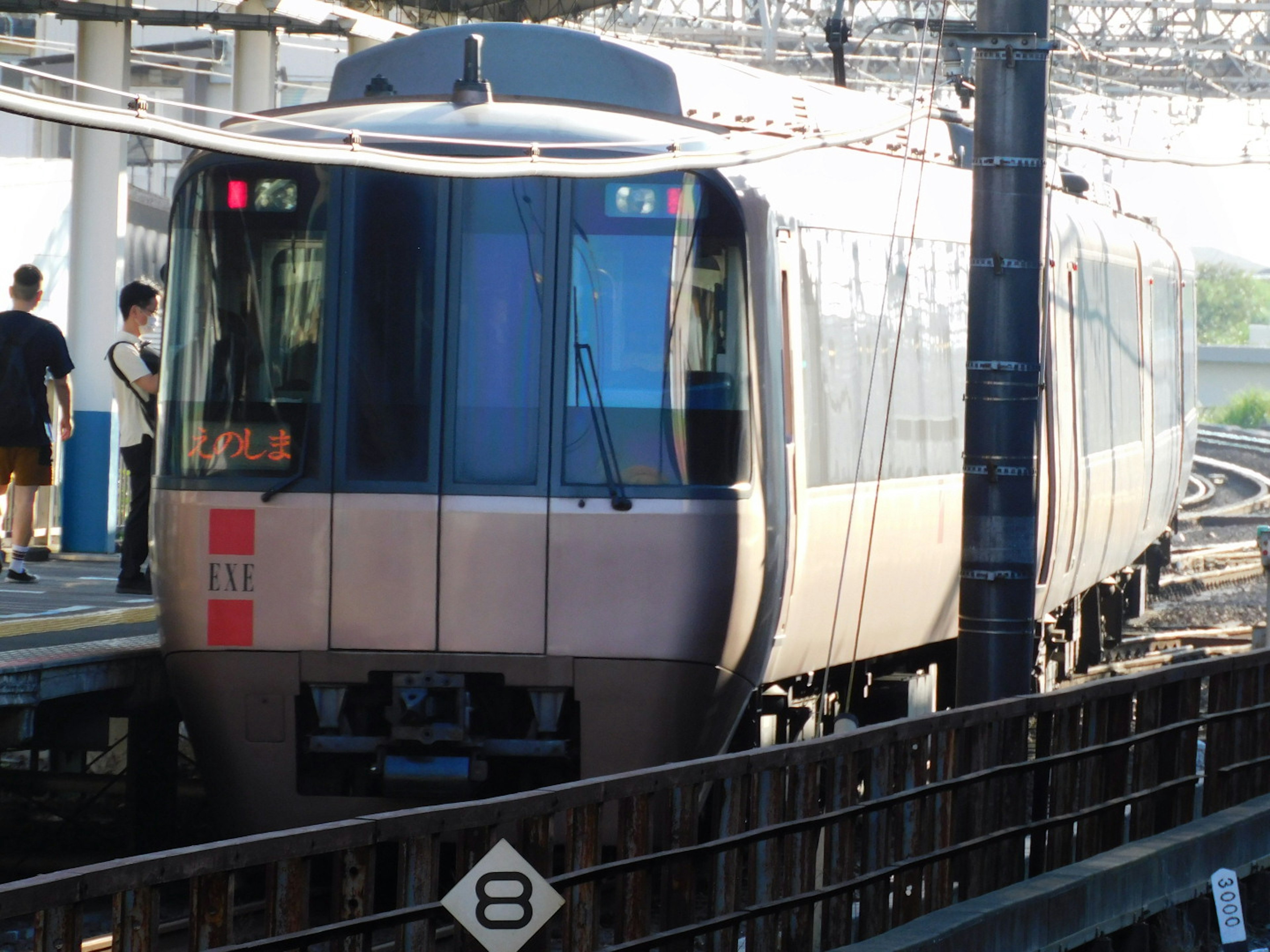 Modern train stopped at the station with people nearby