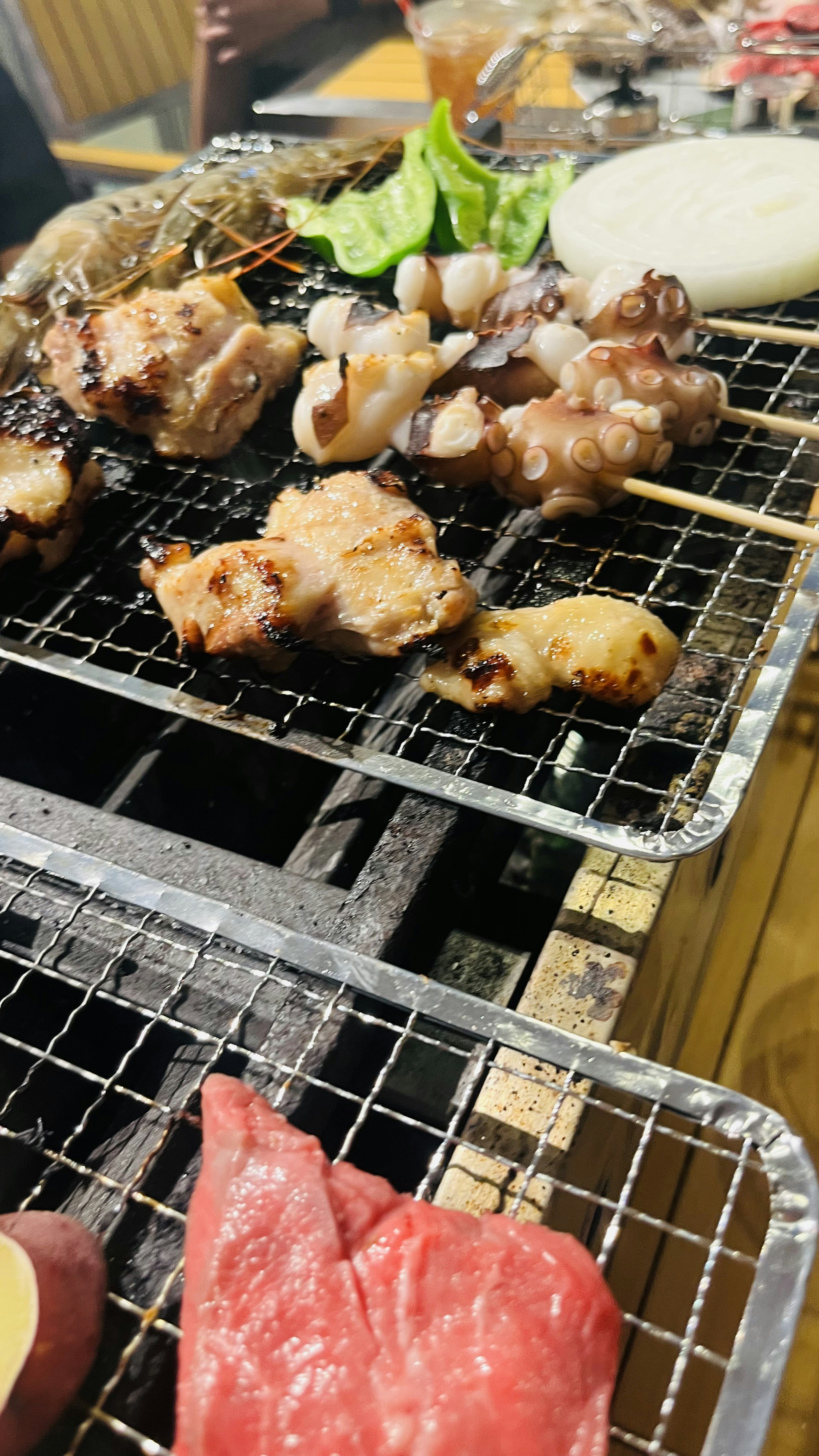 Grilled skewers of chicken and meat being cooked on a barbecue