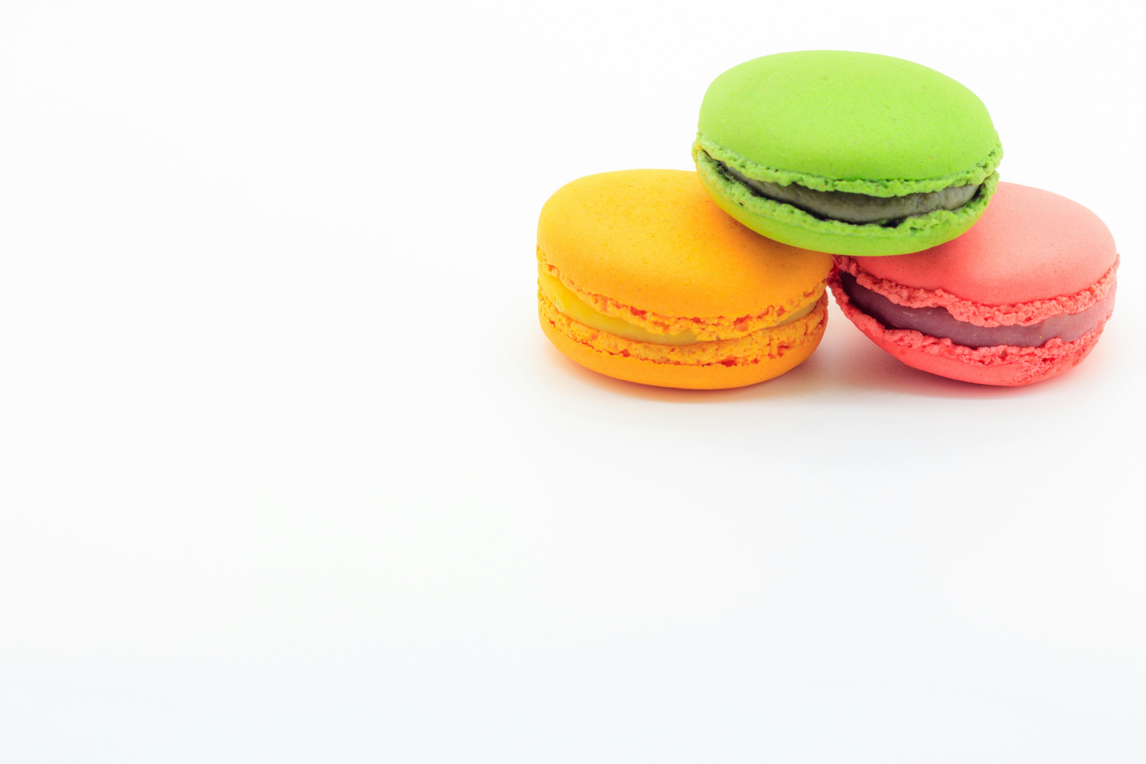 Colorful macarons arranged on a white background