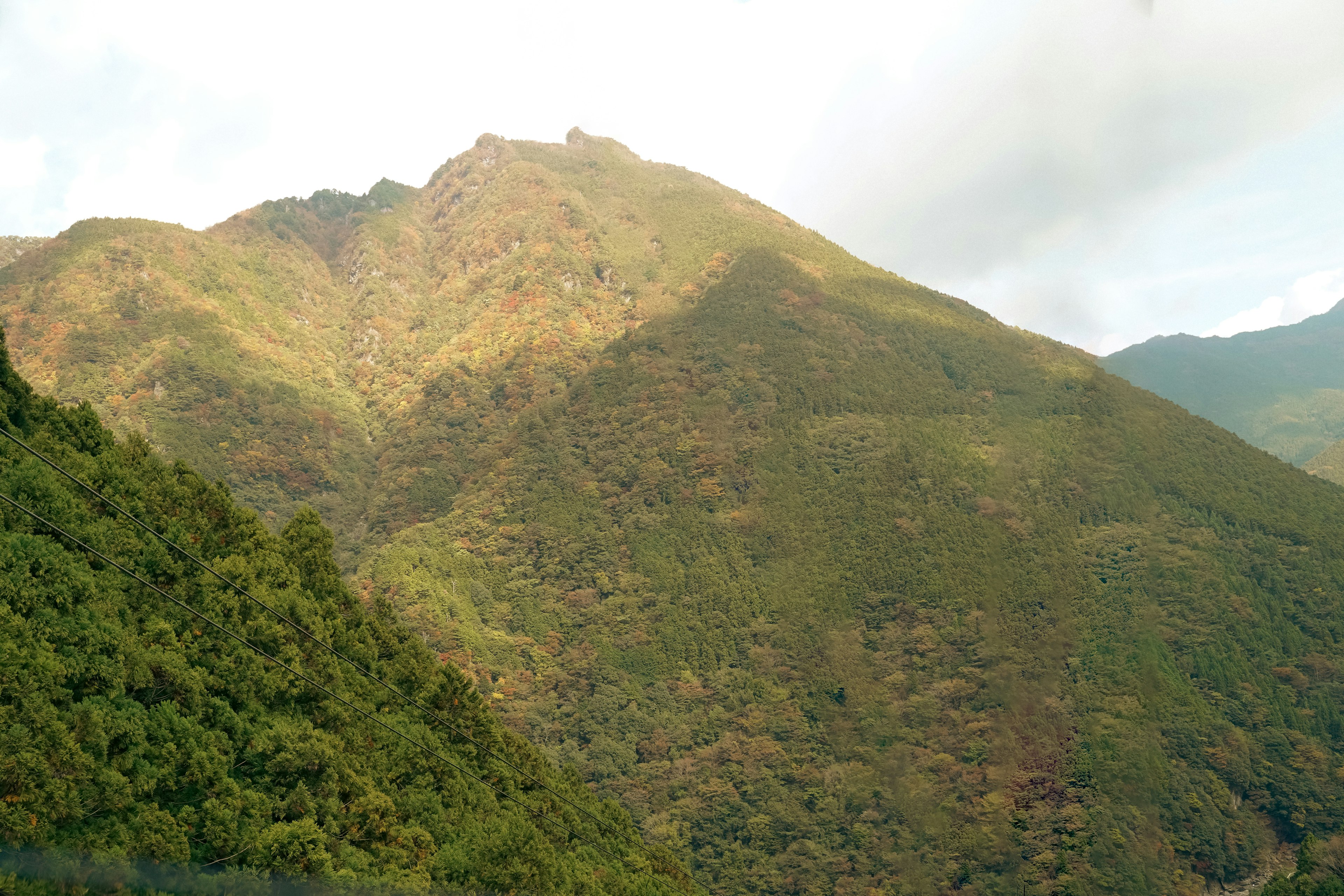 Lush green mountain with shadowed slopes